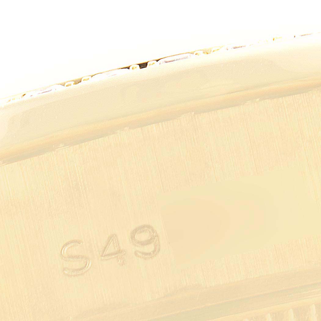The image shows a close-up angle of part of the gold casing and engraved serial number of the Rolex Datejust 69158 Women's Yellow Gold Champagne Dial 69158 Women's Yellow Gold Champagne Dial model.
