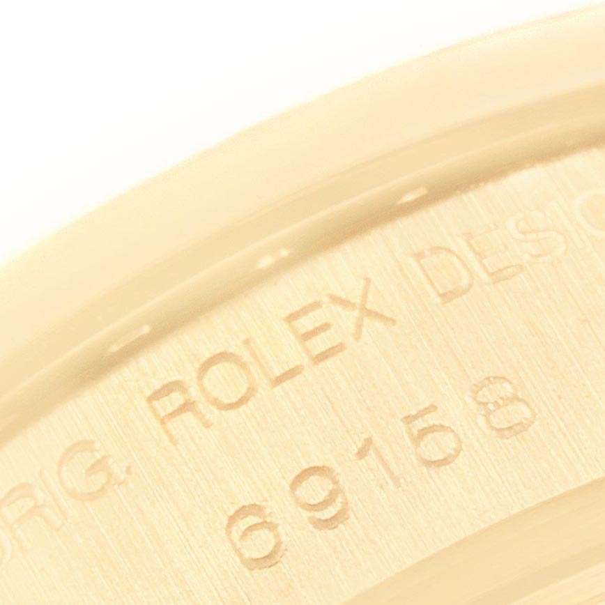 This close-up image shows the engraved model number 69158 on the case of a Rolex Datejust 69158 Women's Yellow Gold Champagne Dial 69158 Women's Yellow Gold Champagne Dial watch.