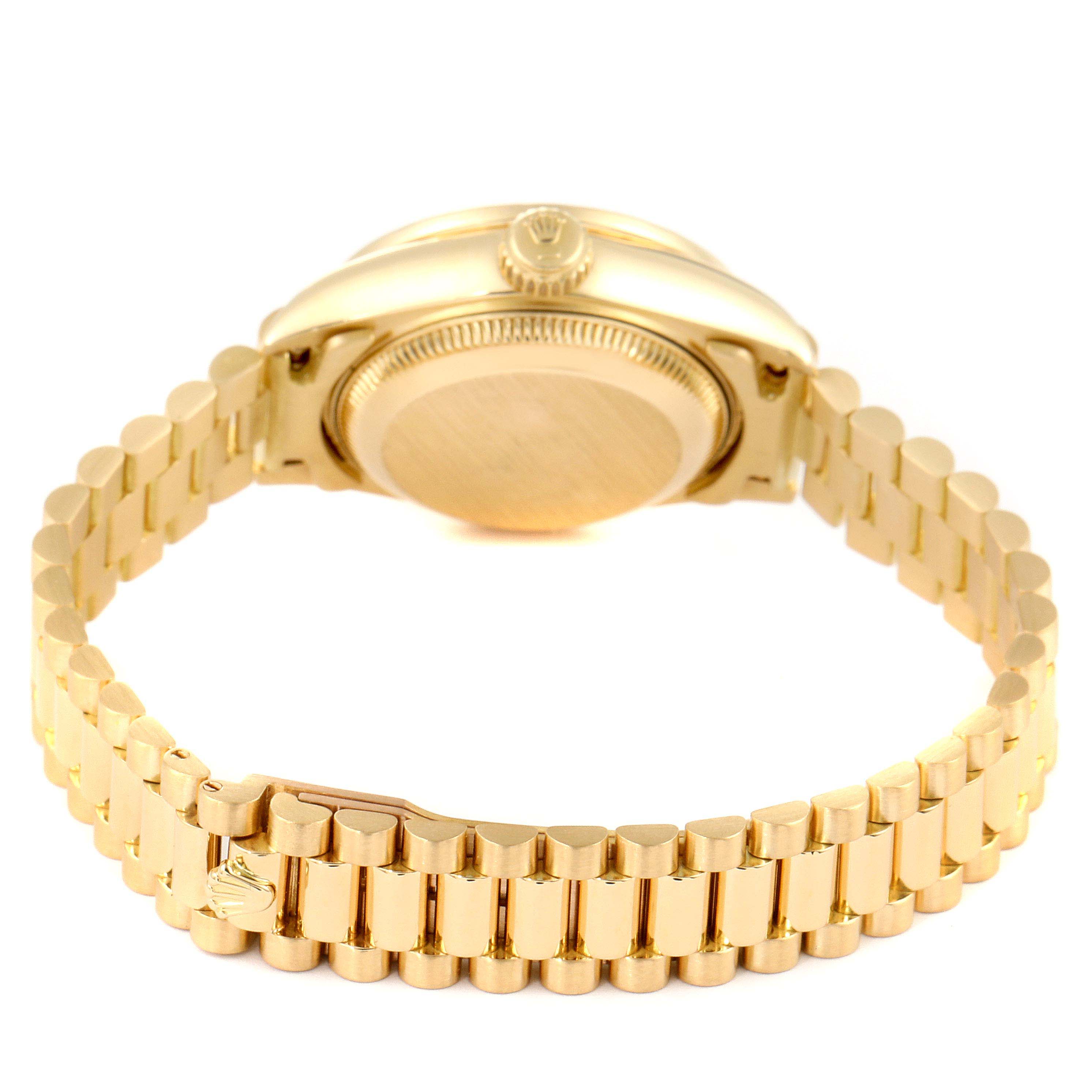 The image shows the back of a Rolex Datejust 69158 Women's Yellow Gold Champagne Dial 69158 Women's Yellow Gold Champagne Dial watch, displaying its case back and a gold bracelet.