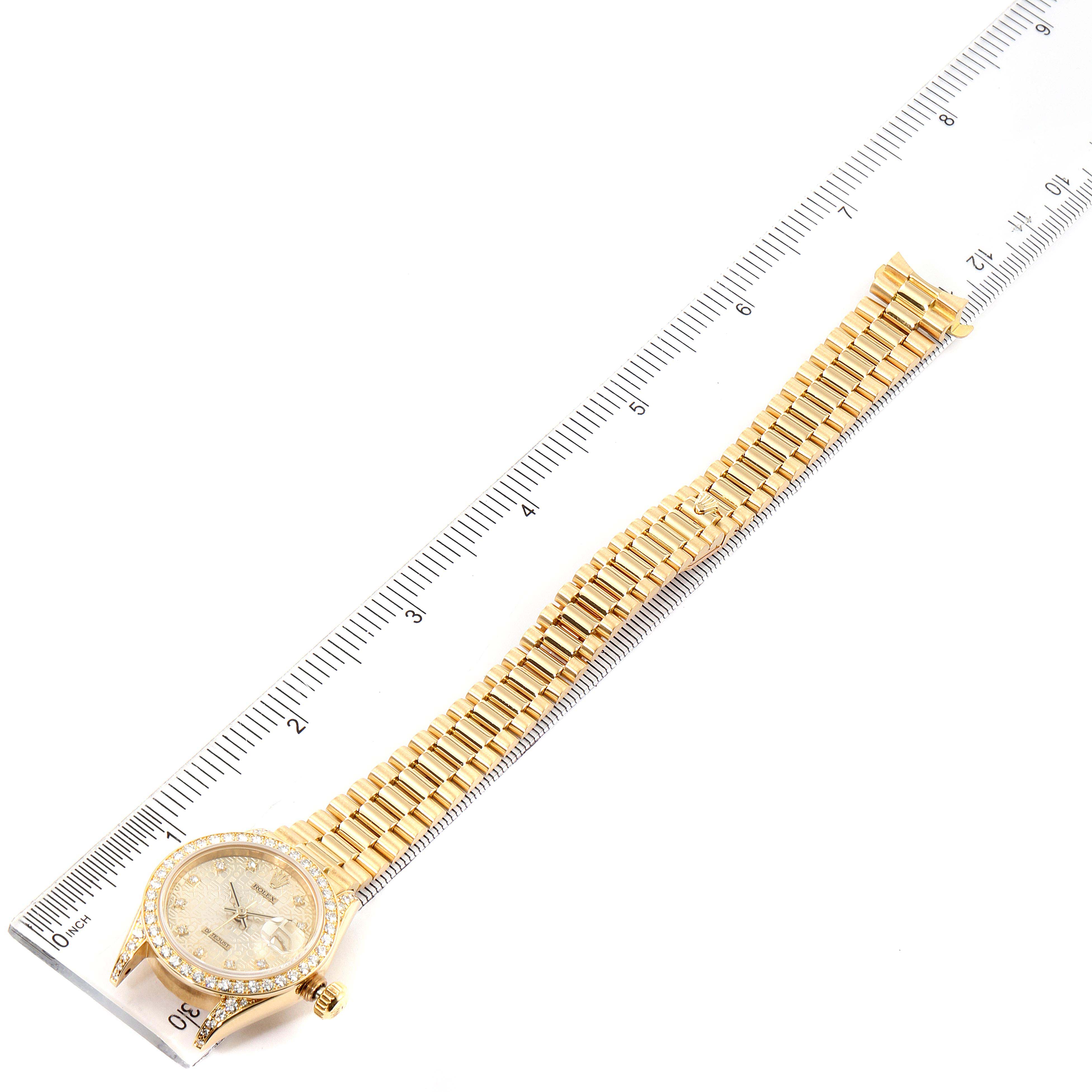 The Rolex Datejust 69158 Women's Yellow Gold Champagne Dial 69158 Women's Yellow Gold Champagne Dial watch is shown from a top-down angle, displaying the entire watch including the dial, case, and bracelet.