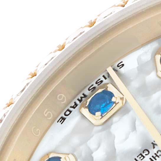The image shows a close-up of the dial of a Rolex President 179138 Women's Yellow Gold Mother of Pearl Dial watch, featuring a gemstone hour marker and part of the minute hand.