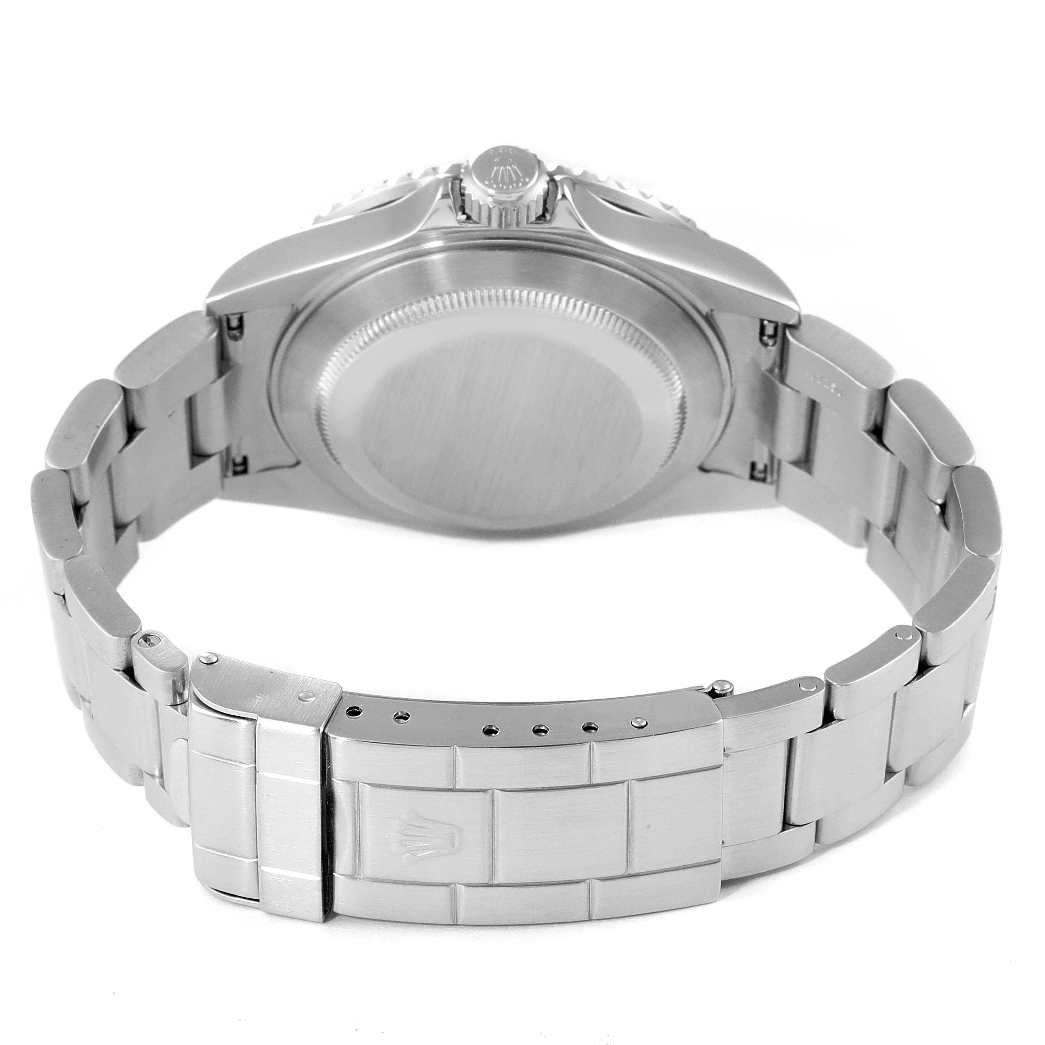 The image shows the backside of the Rolex Submariner 16610 Men
s Stainless Steel Black Dial 16610 Men
s Stainless Steel Black Dial watch, including its case back, crown, and bracelet.