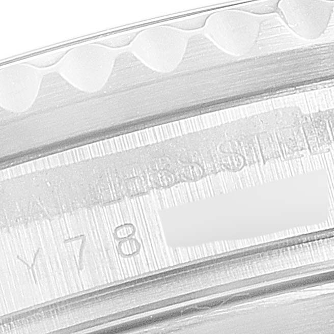 This image shows a close-up of the engraved side of the bezel on a Rolex Submariner 16610 Men
s Stainless Steel Black Dial 16610 Men
s Stainless Steel Black Dial watch.