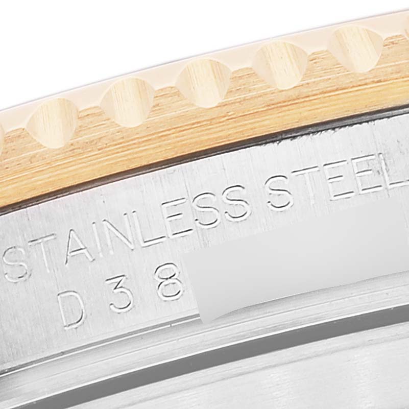 This close-up image shows a portion of the stainless steel case and the engraved bezel of a Rolex Submariner 16613 Men's Steel and Gold (two tone) Blue Dial 16613 Men's Steel and Gold (two tone) Blue Dial watch.