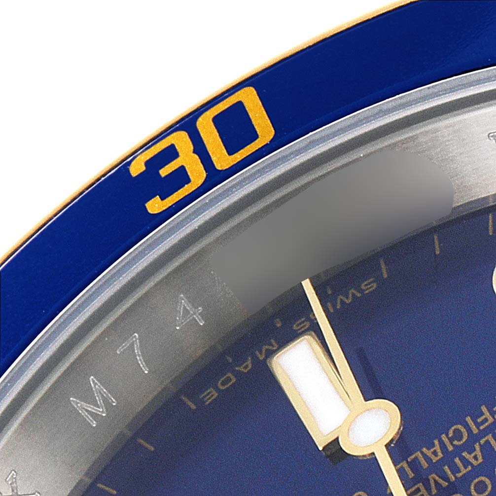 The image shows a close-up of a Rolex Submariner 16613 Men
s Steel and Gold (two tone) Blue Dial 16613 Men
s Steel and Gold (two tone) Blue Dial watch, focusing on the 30-minute mark on the bezel and part of the dial.