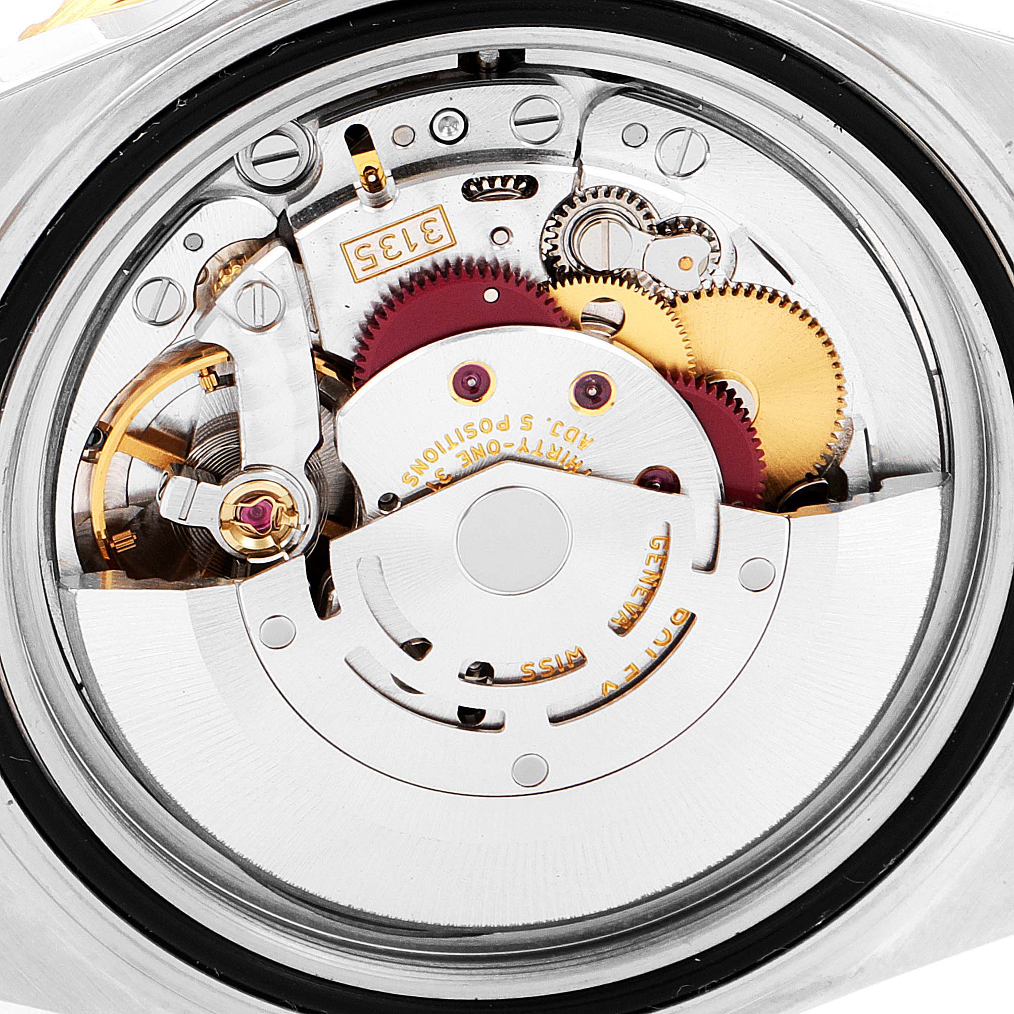 This image shows the internal mechanism of a Rolex Submariner 16613 Men
s Steel and Gold (two tone) Blue Dial 16613 Men
s Steel and Gold (two tone) Blue Dial watch, including gears and the movement assembly.