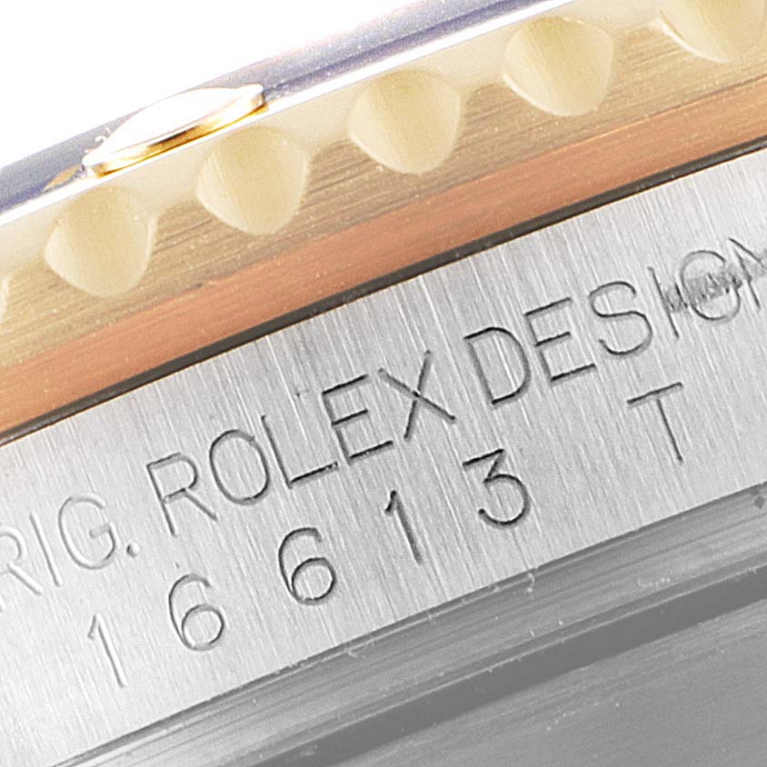 The image shows a close-up of the engraved inner bezel and part of the outer bezel of the Rolex Submariner 16613 Men
s Steel and Gold (two tone) Blue Dial 16613 Men
s Steel and Gold (two tone) Blue Dial watch.