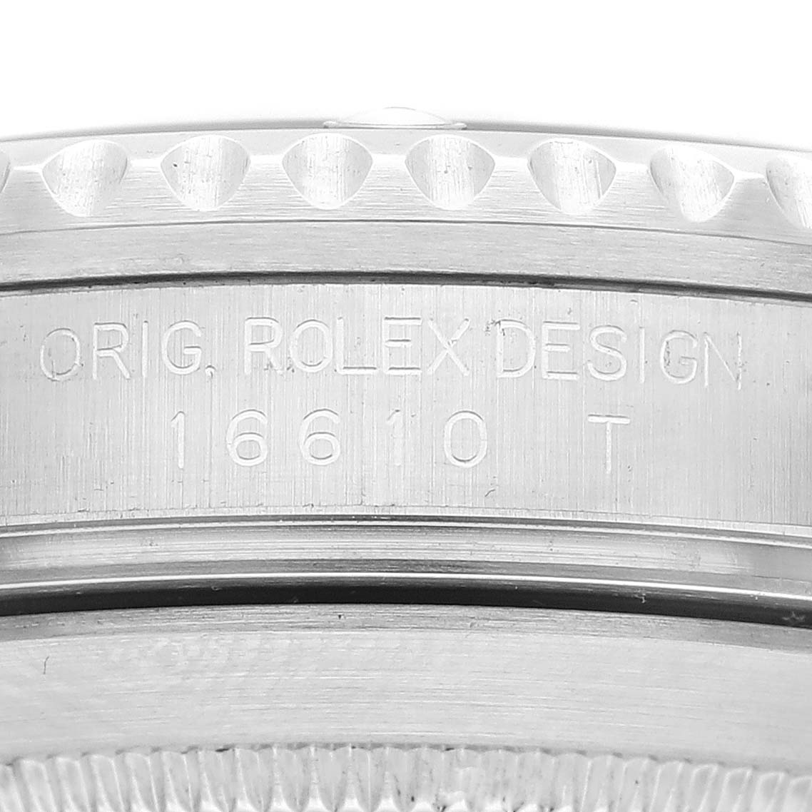 The image shows a close-up of the engraved side of a Rolex Submariner 16610 Men
s Stainless Steel Black Dial 16610 Men
s Stainless Steel Black Dial watch case with model number 16610 T.