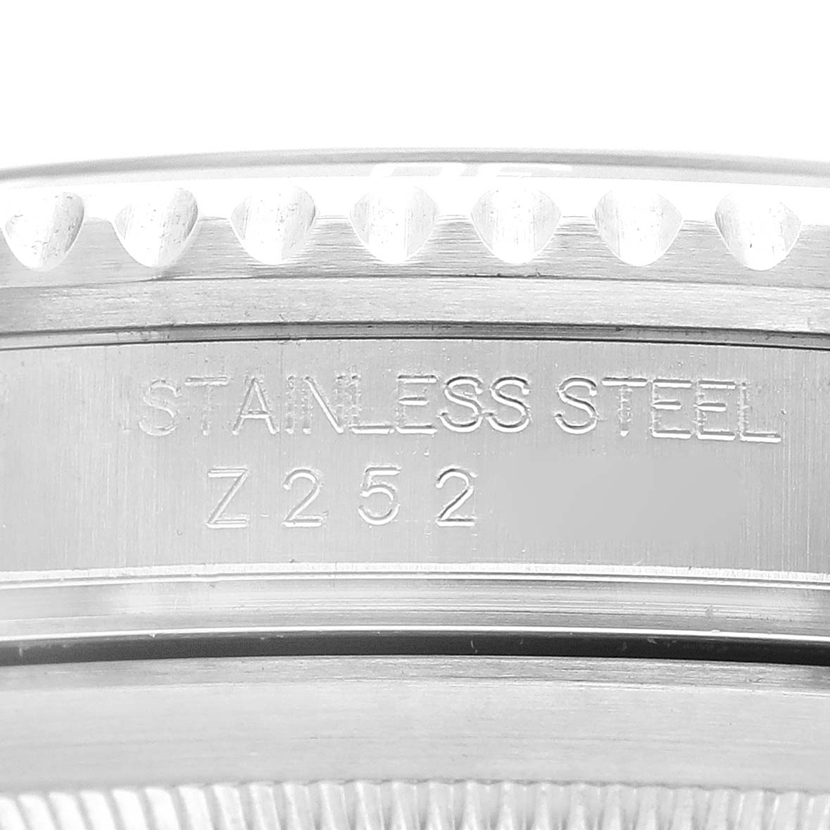 The image shows a close-up angle of the bezel and side engraving of a Rolex Submariner 16610 Men
s Stainless Steel Black Dial 16610 Men
s Stainless Steel Black Dial watch, highlighting the "Stainless Steel" inscription.