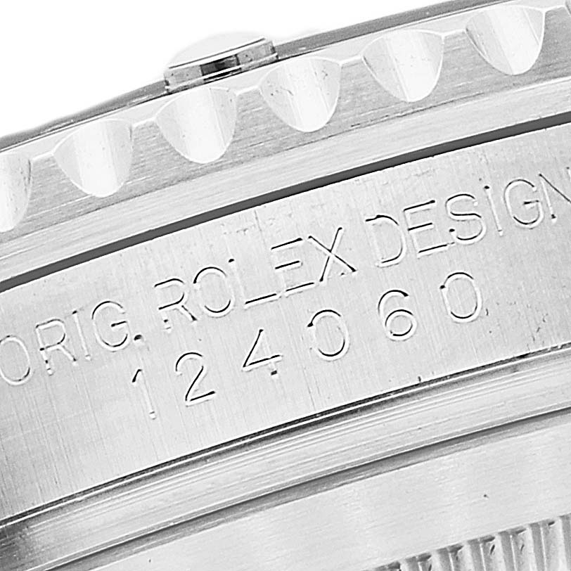 This image shows an angled close-up of the model number engraved on a Rolex Submariner 124060 Men's Stainless Steel Black Dial 124060 Men's Stainless Steel Black Dial watch case.