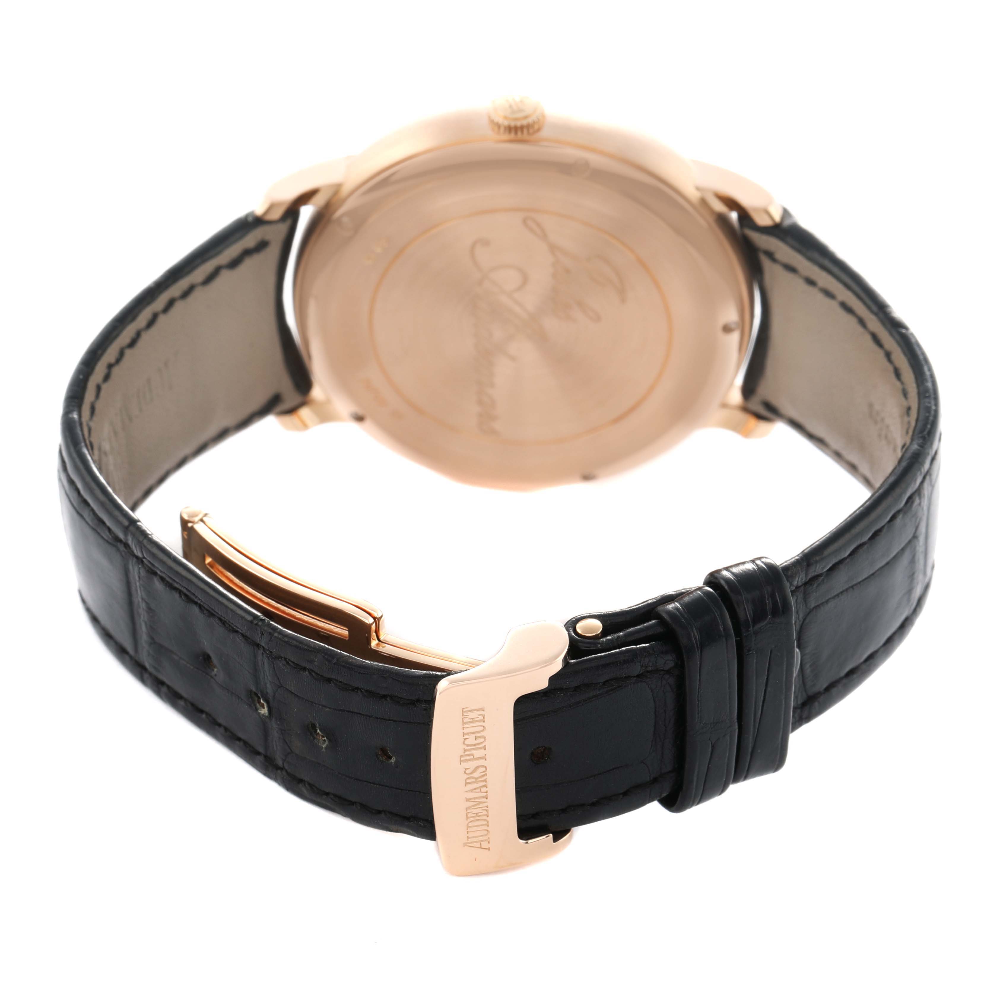 The image shows the back and strap of an Audemars Piguet Jules 26380OR Men's Rose Gold Black Dial watch, highlighting its clasp and engraved case back.