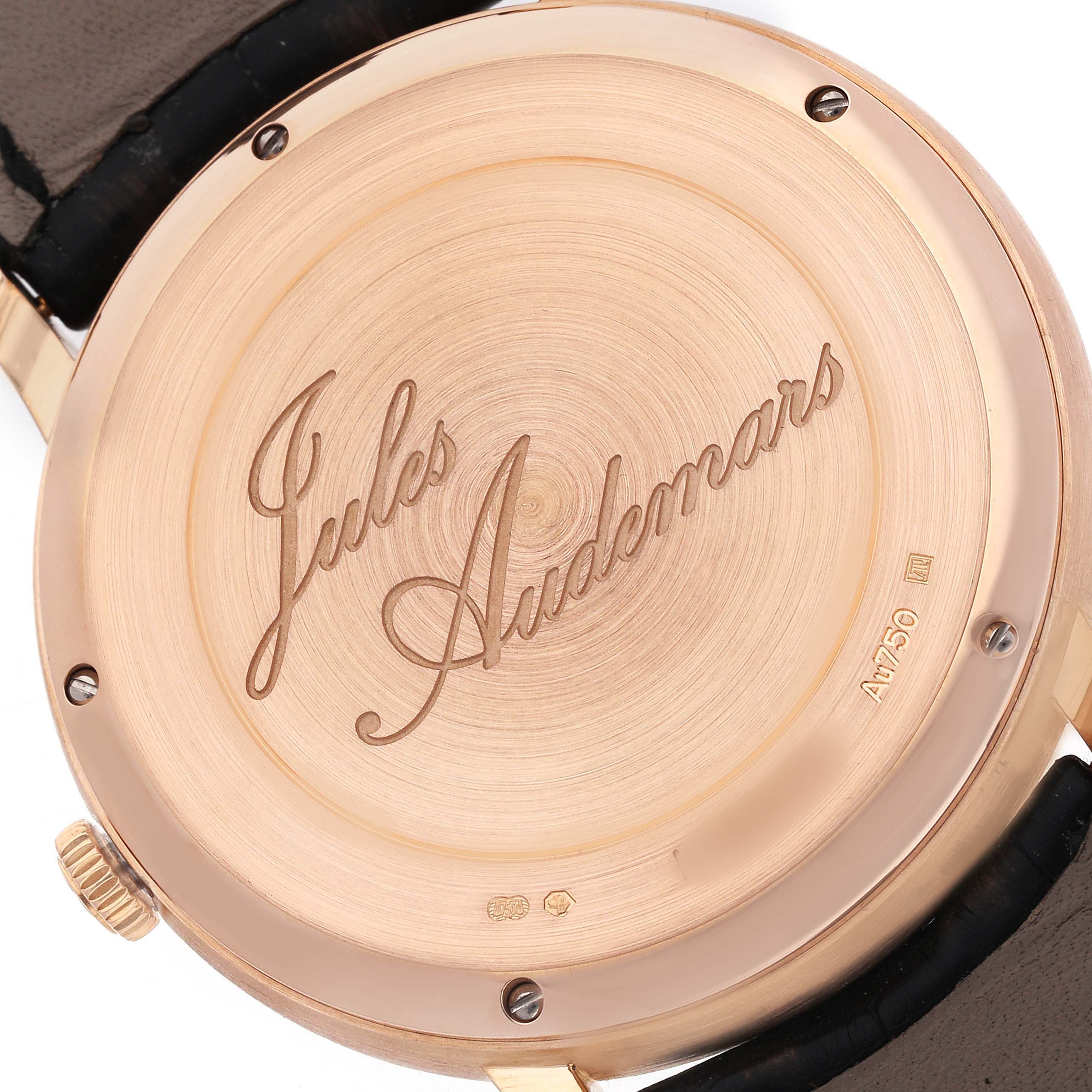 The image shows the back case of a Jules Audemars Piguet watch, featuring engraved branding and screws.