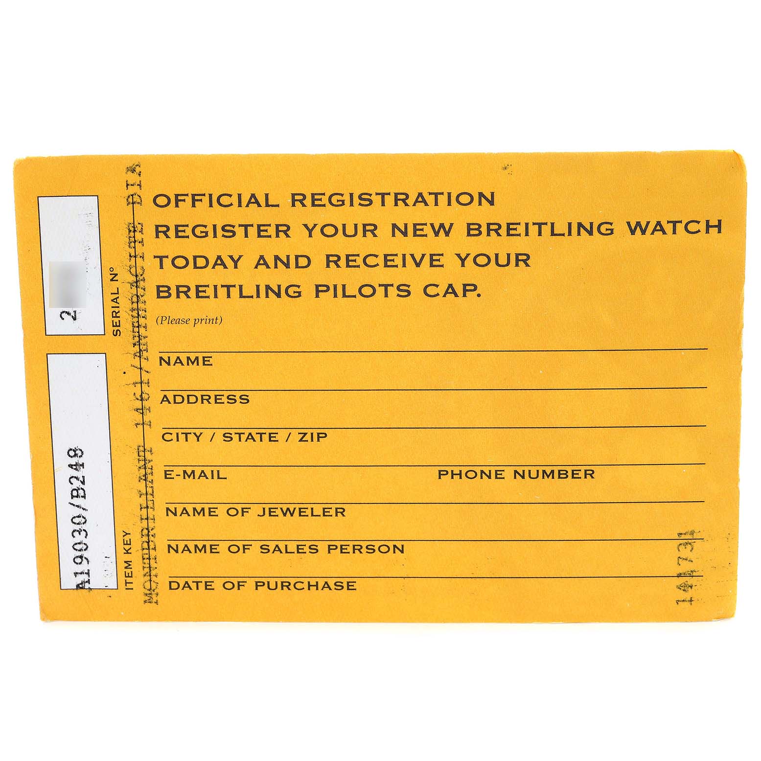 This image shows a flat lay of a yellow official registration card for a Breitling Navitimer A19030 Men's Stainless Steel Black Dial A19030 Men's Stainless Steel Black Dial watch.