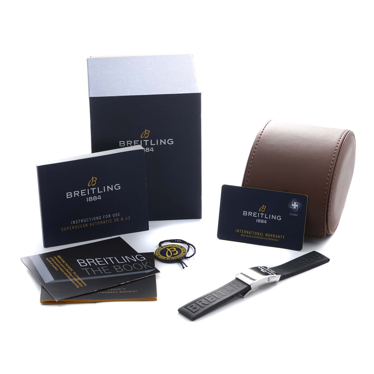 The image shows the Breitling Superocean A17366 Men's Stainless Steel Black Dial accessories: box, manuals, warranty card, luggage tag, spare strap, and case from an overhead view.