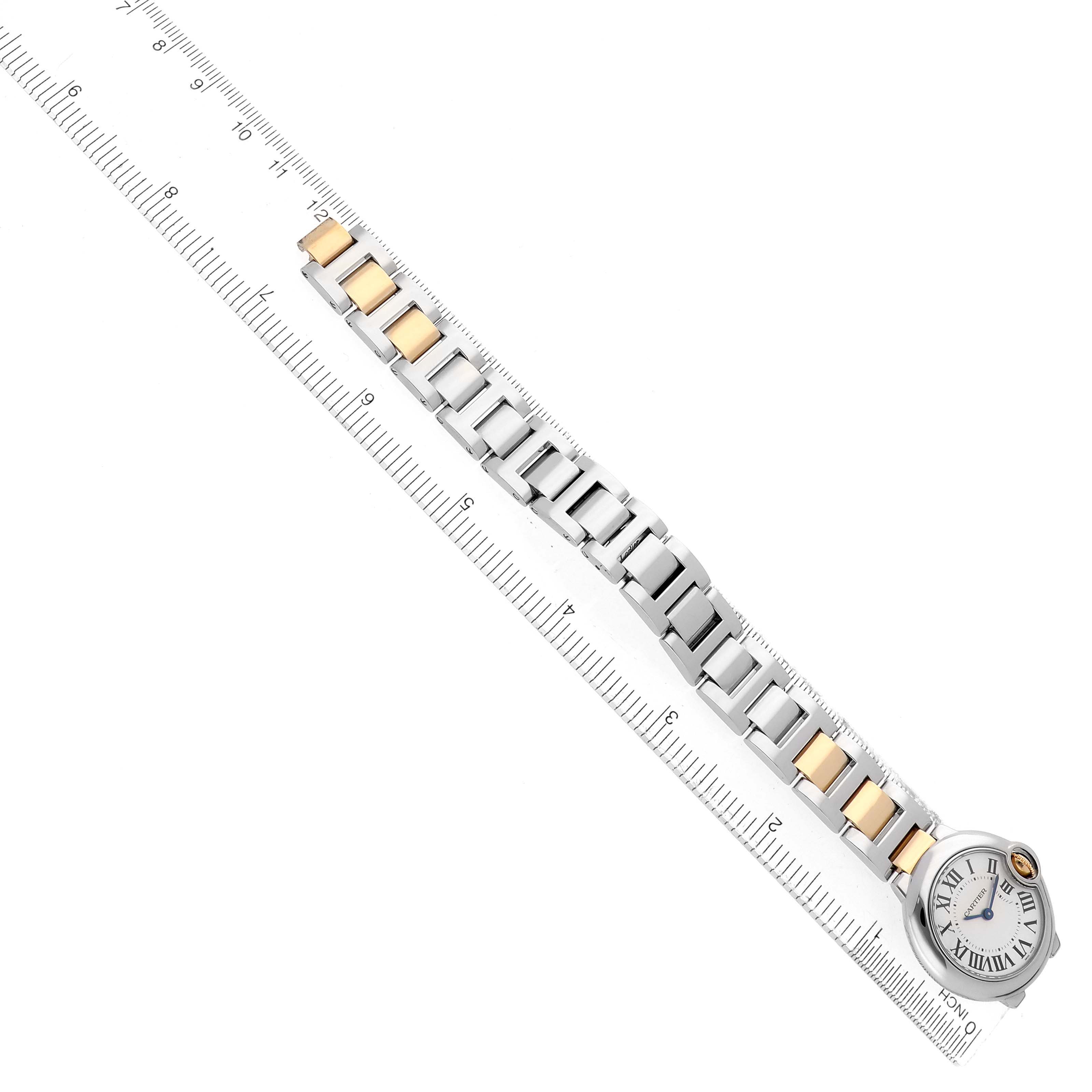 The Cartier Ballon Bleu W69007Z3 Women's Steel and Gold (two tone) Silver Dial watch is shown from a top view, highlighting its full band and face with a ruler for scale.