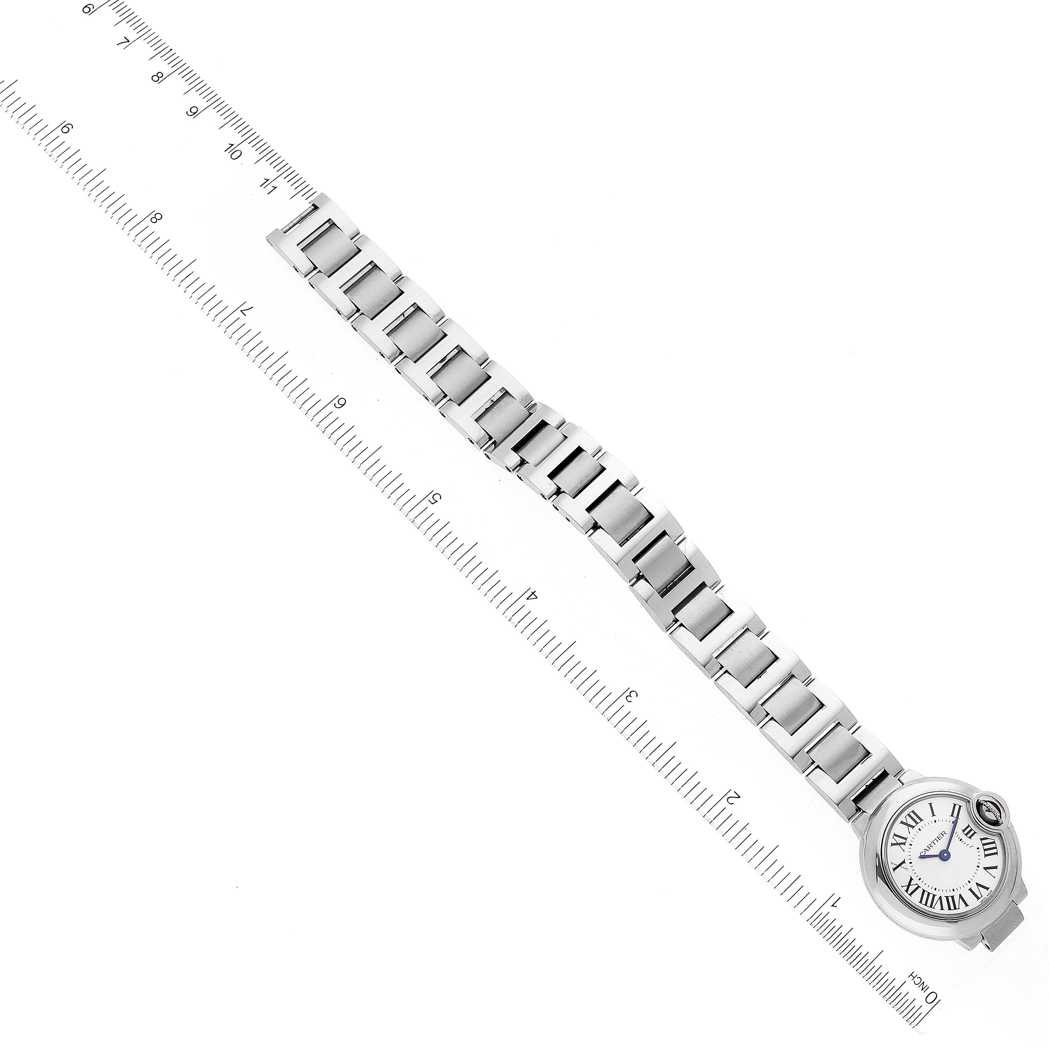 The image shows a fully extended Ballon Bleu de Cartier watch bracelet and face laid flat next to a ruler for measurement.