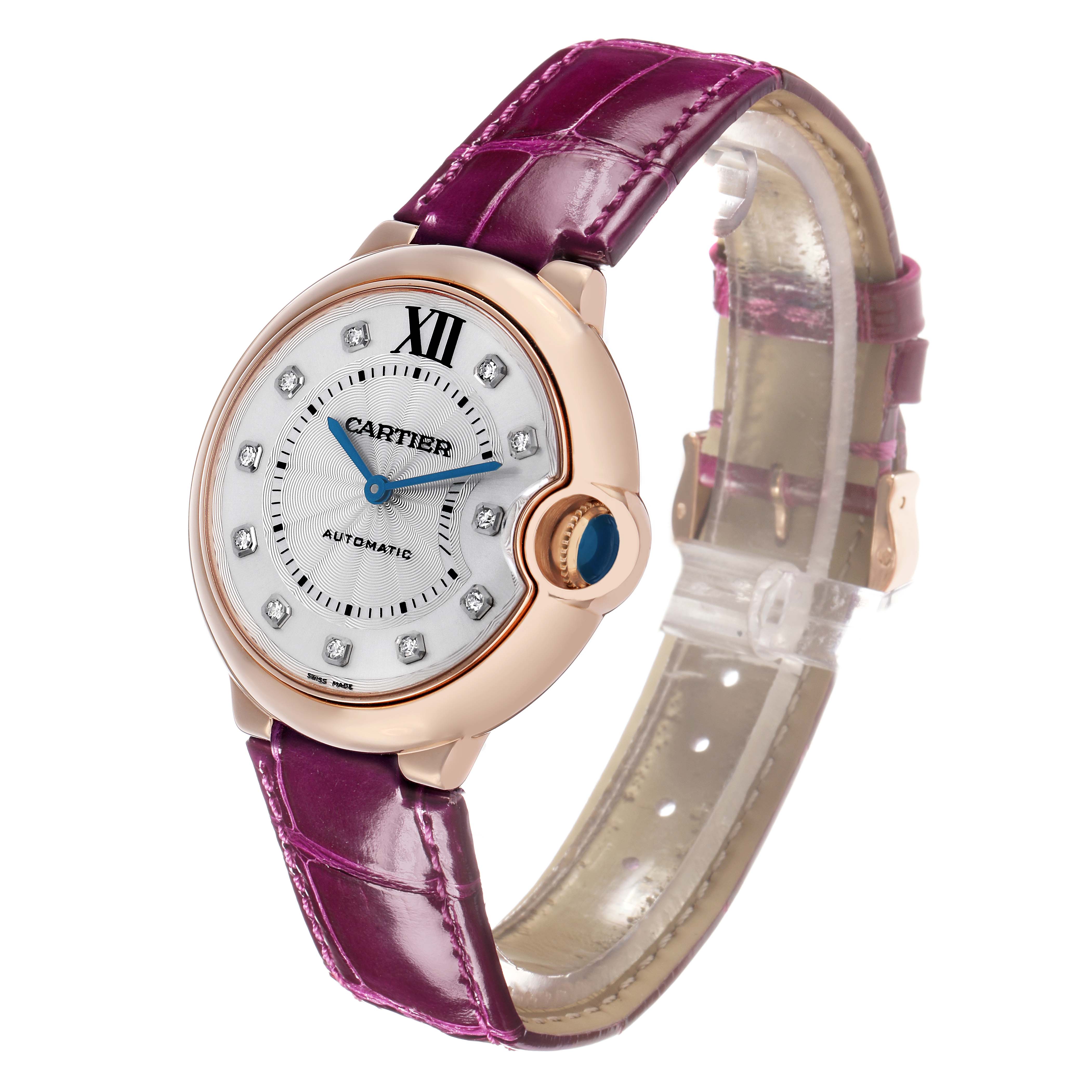 The Cartier Ballon Bleu WE902028 Women's Rose Gold Silver Dial watch is shown at an angled front view, highlighting the dial, case, and purple strap.