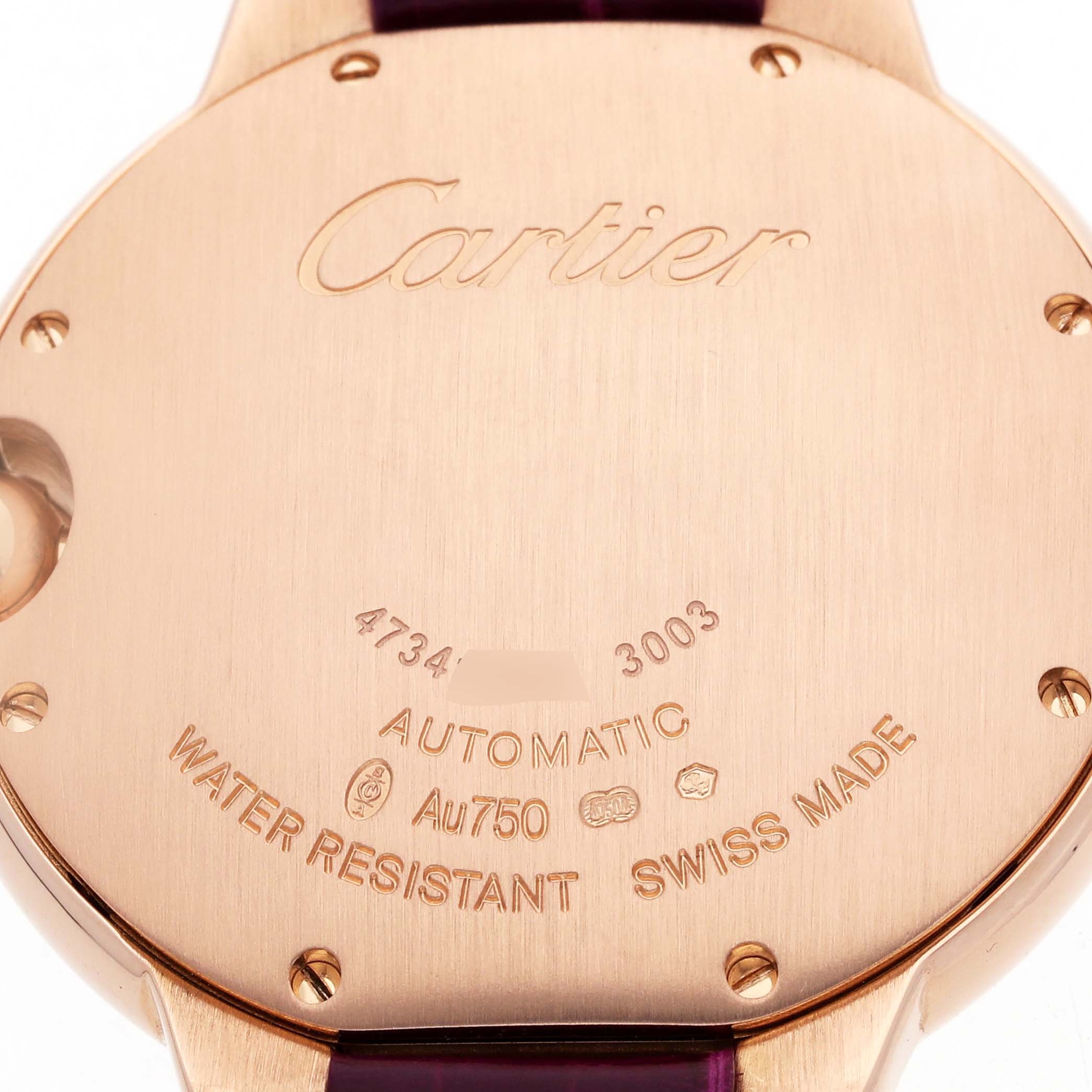 The image shows the back of a Cartier Ballon Bleu WE902028 Women's Rose Gold Silver Dial watch with engravings, highlighting its automatic movement and craftsmanship.