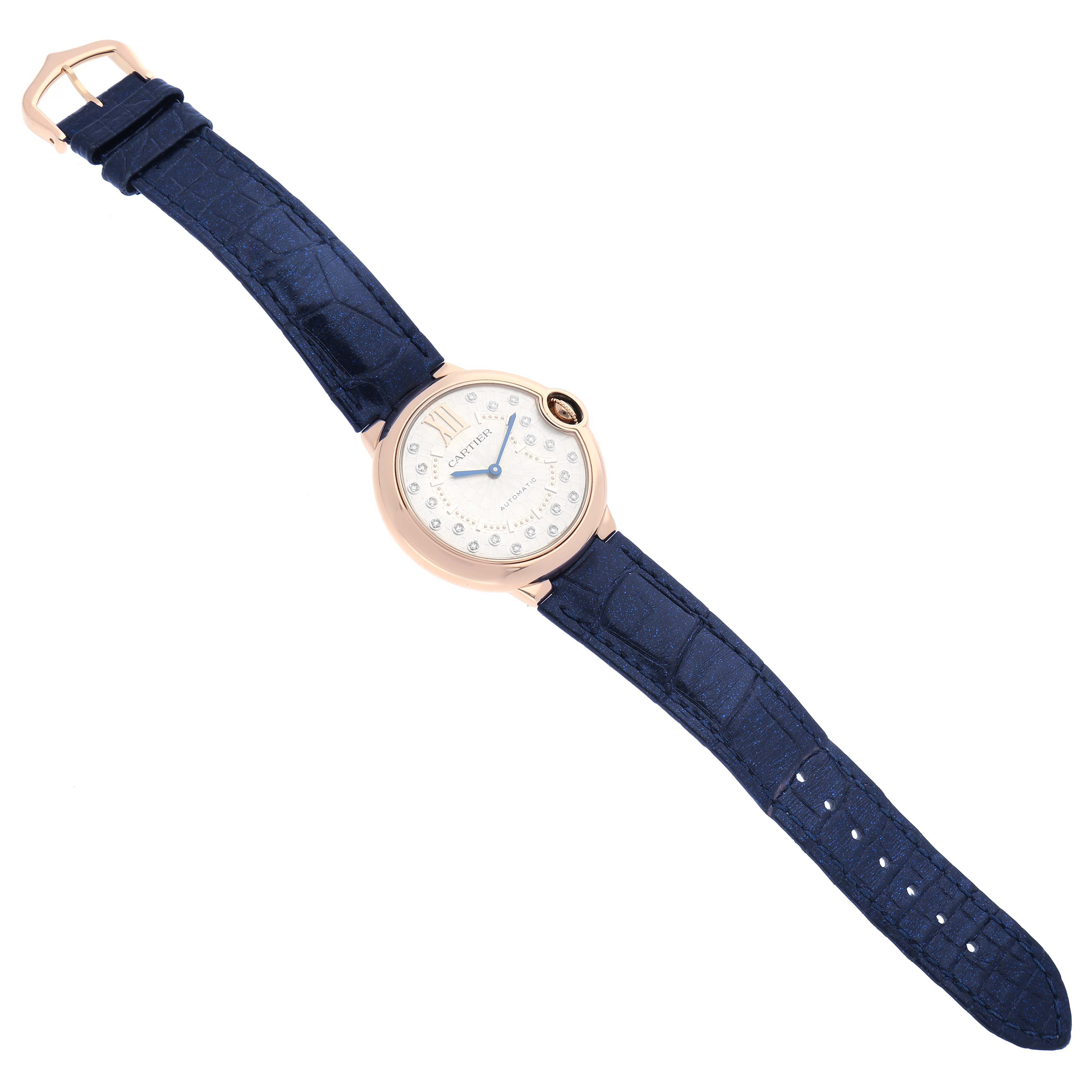 The Cartier Ballon Bleu WGBB0053 Women's Rose Gold Silver Dial WGBB0053 Women's Rose Gold Silver Dial watch is shown from above, displaying the full watch face and blue strap.