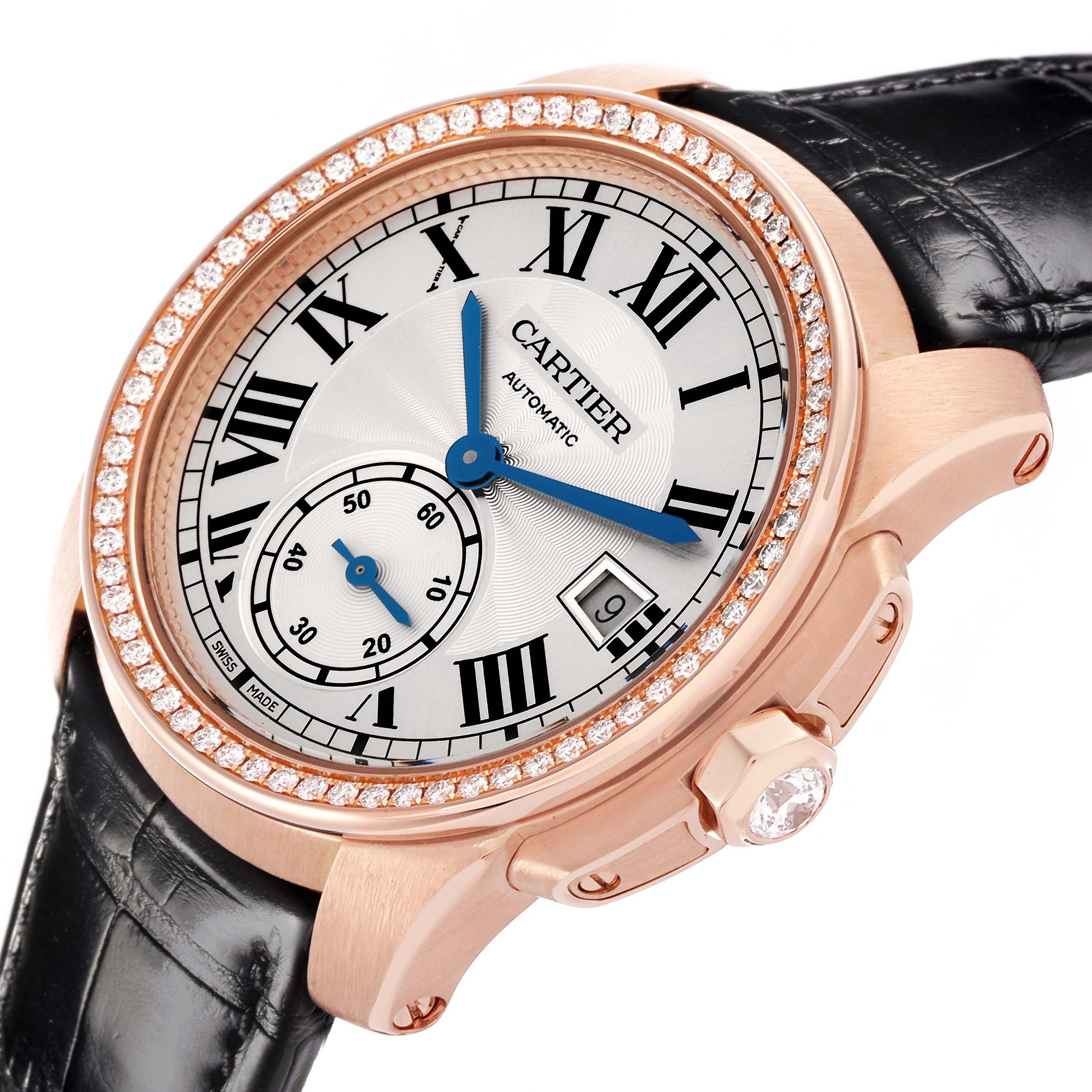 The Calibre de Cartier watch is shown at an angled view, highlighting its diamond bezel, Roman numeral dial, and crown with a gemstone.