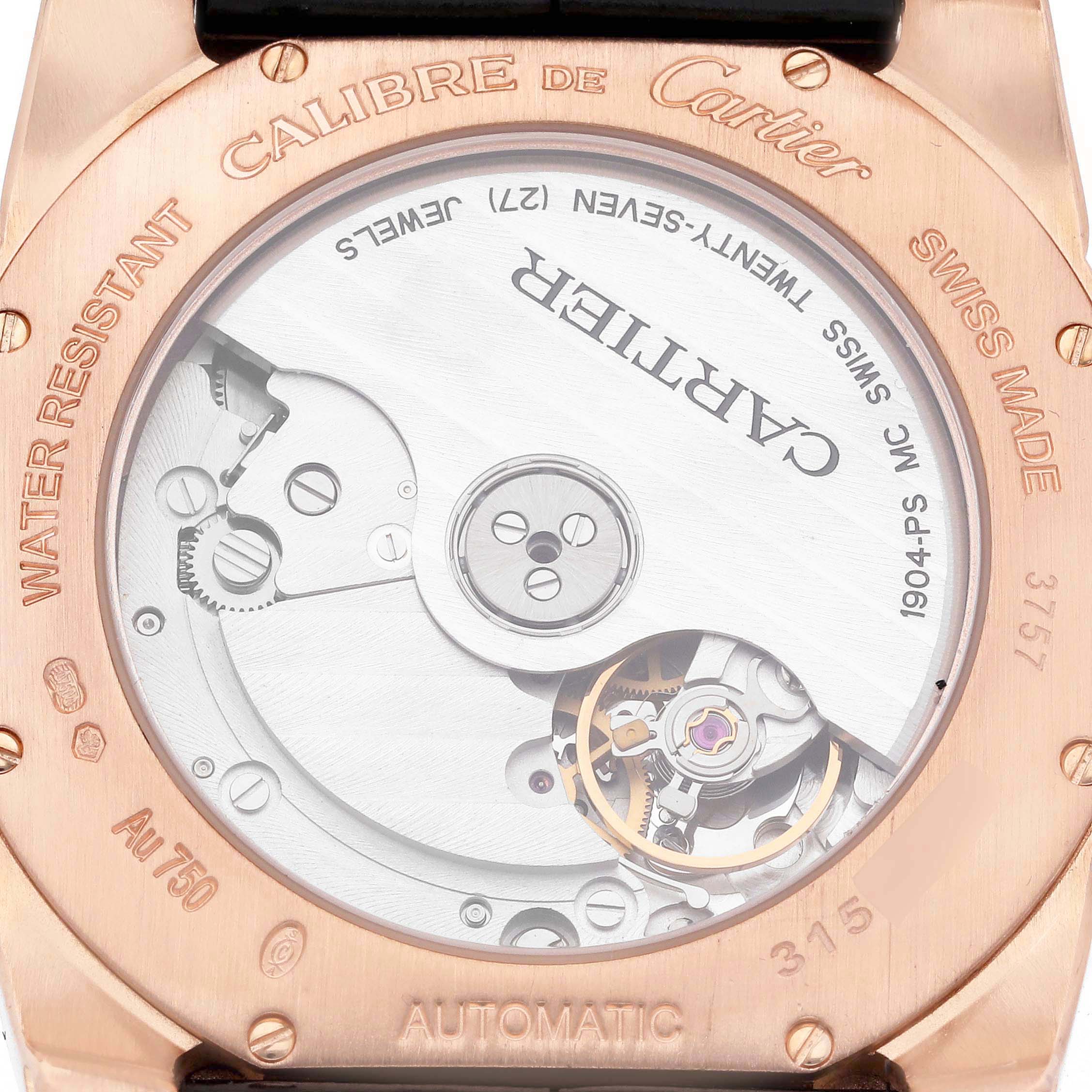 The image shows the back view of a Calibre de Cartier watch, highlighting its automatic movement and internal mechanisms.