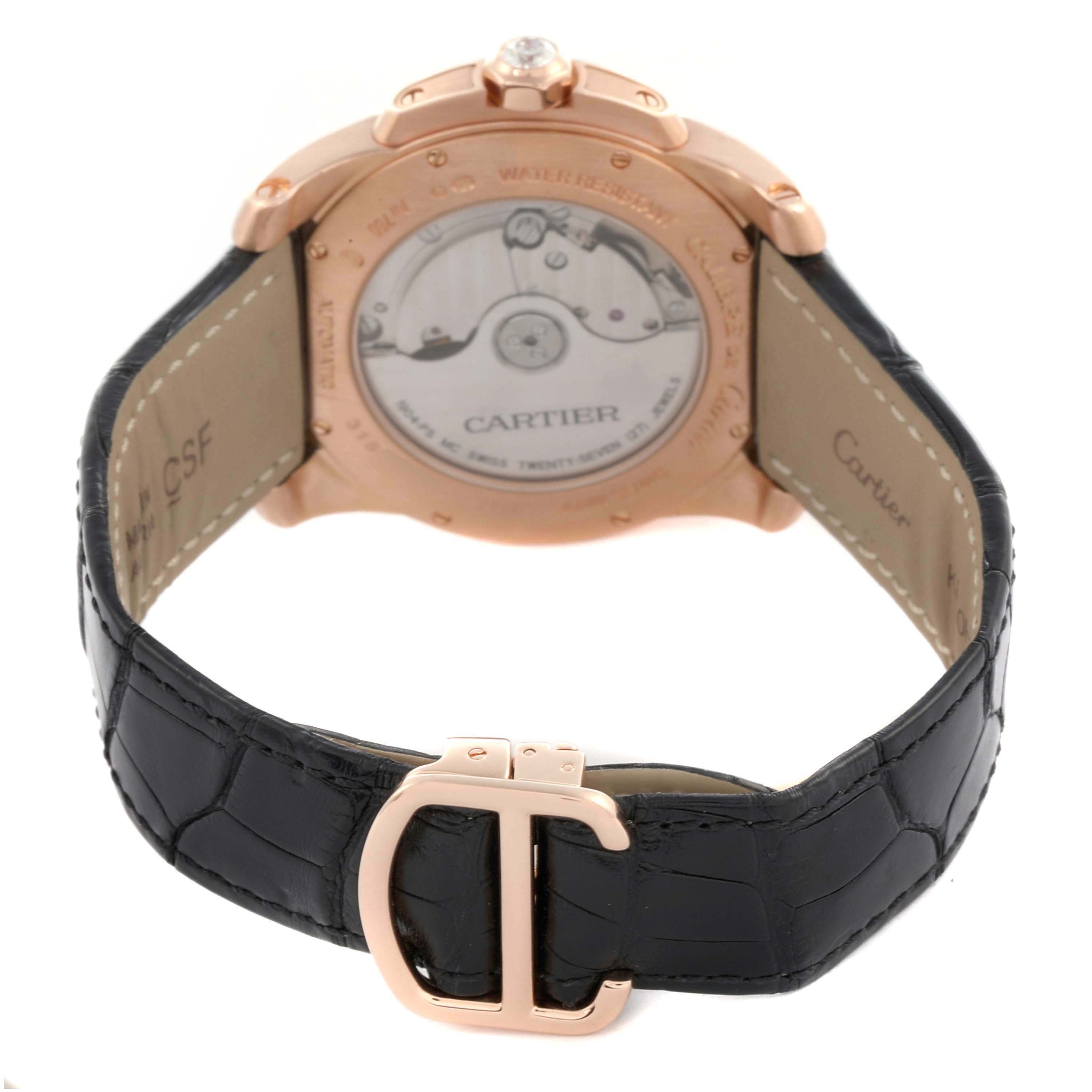 The image shows the back of the Calibre de Cartier watch, highlighting the caseback and leather strap with a prominent clasp.