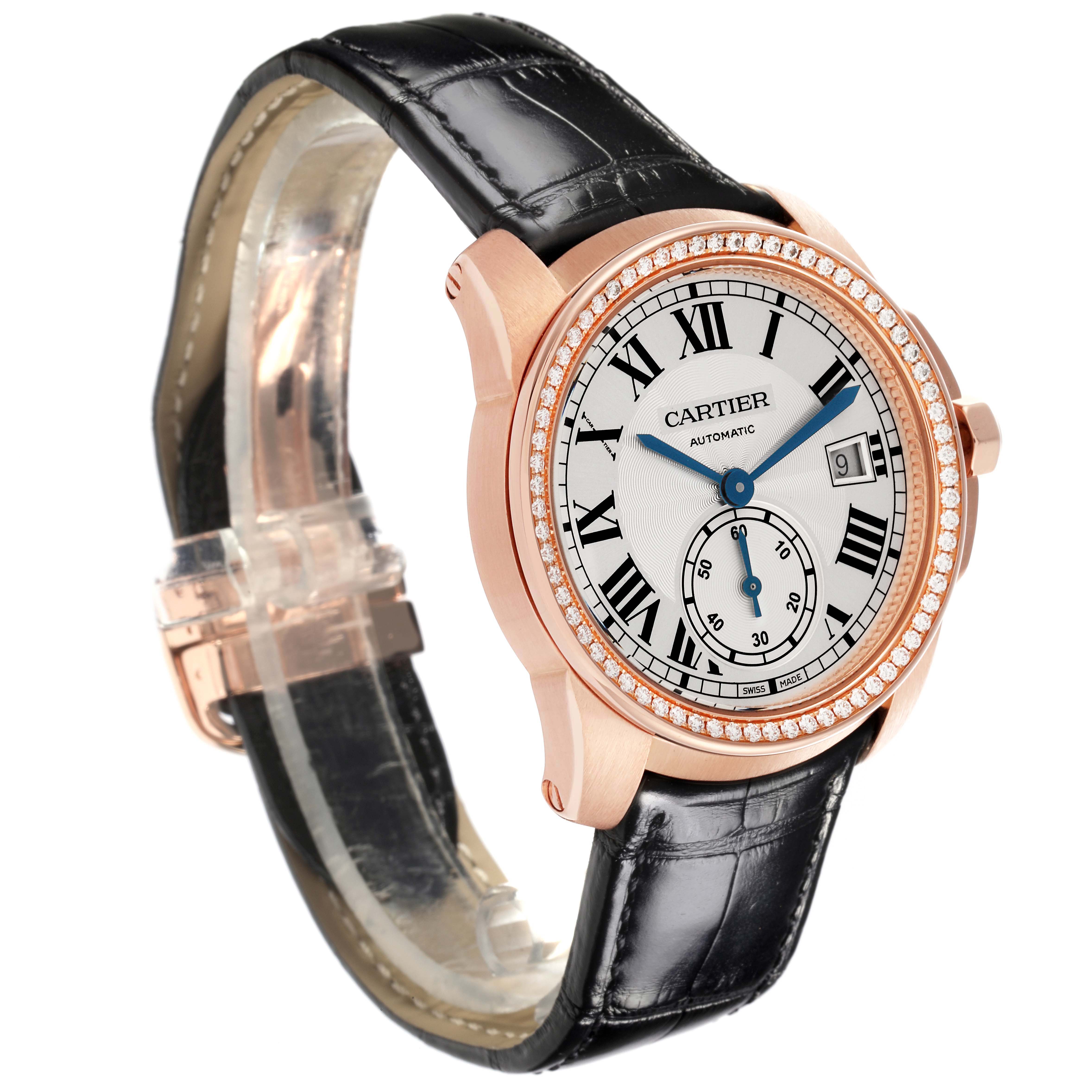 The Calibre de Cartier watch is shown at a slight angle displaying the face, bezel, crown, and part of the black leather strap.