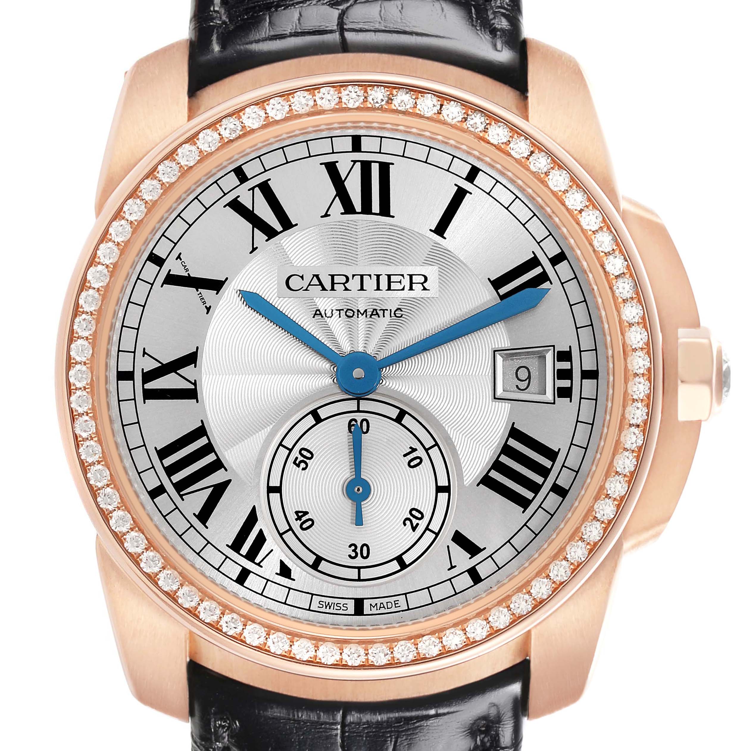 The Calibre de Cartier watch is shown from the front, displaying the face, hands, date window, and diamond-encrusted bezel.
