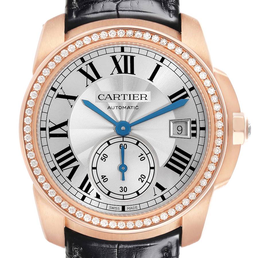 The Calibre de Cartier watch is shown from the front, displaying the face, hands, date window, and diamond-encrusted bezel.