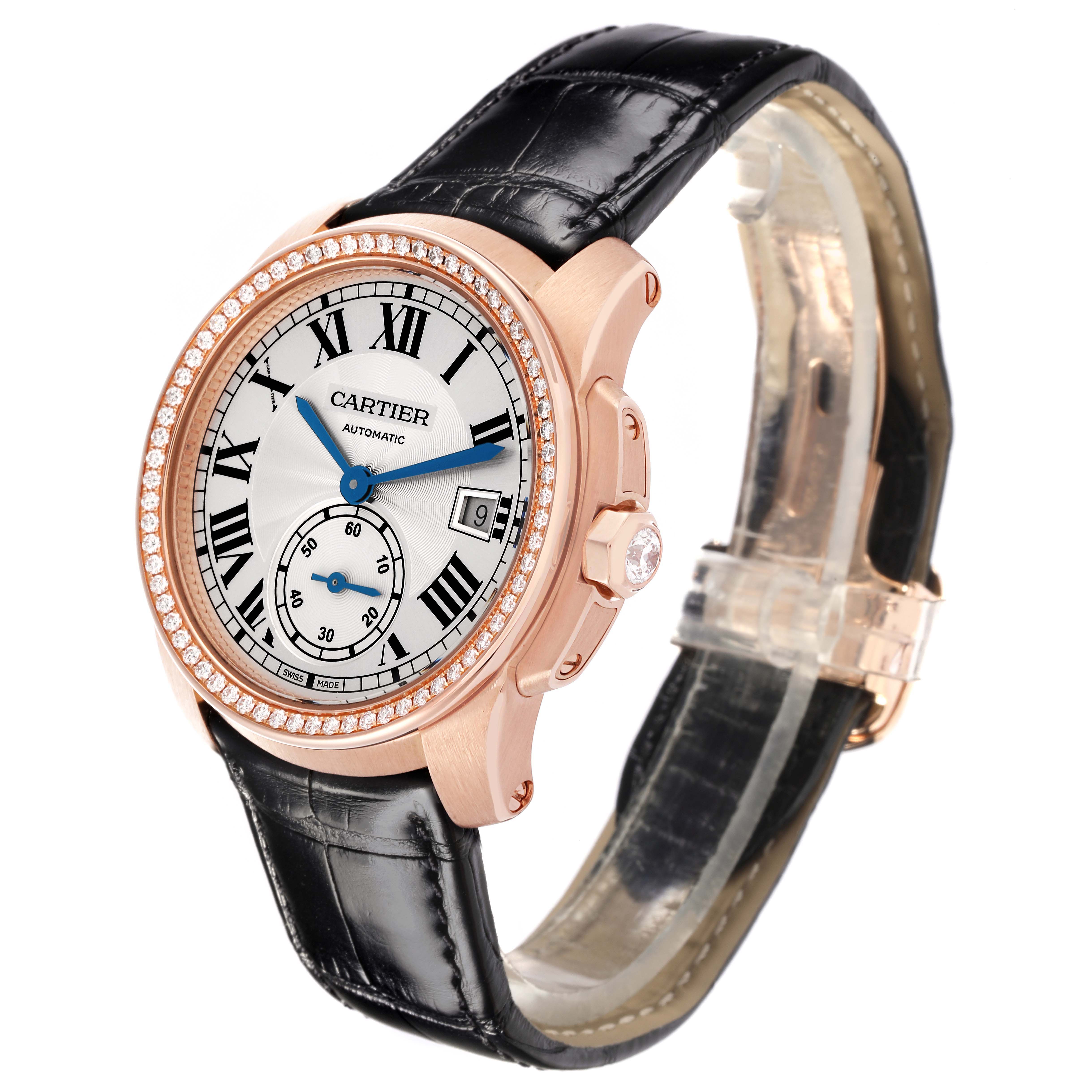 The Calibre de Cartier watch is shown at a three-quarter angle, highlighting the dial, bezel, crown, and leather strap.