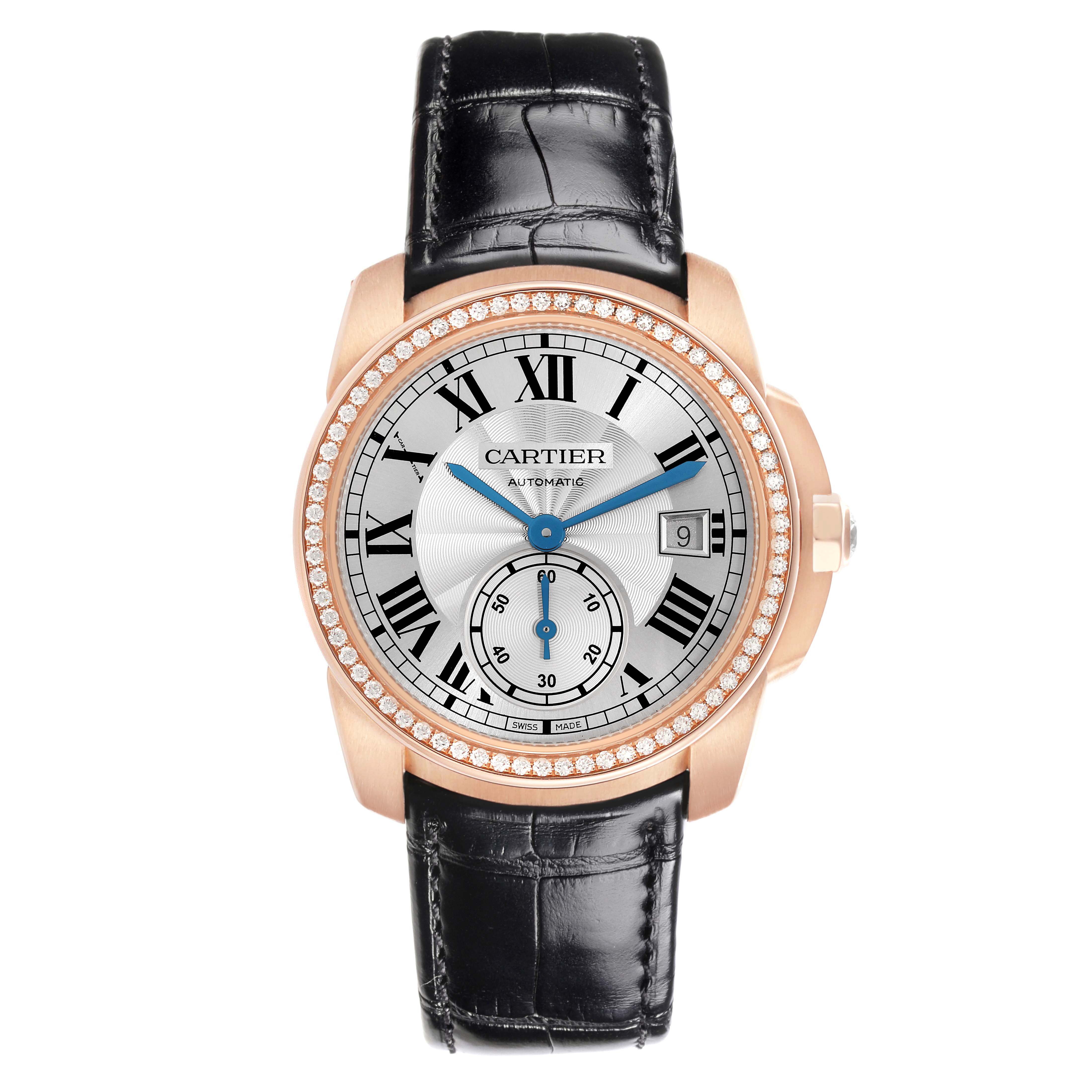 The Calibre de Cartier watch by Cartier is shown from a top-down angle, displaying the watch face, strap, and bezel.
