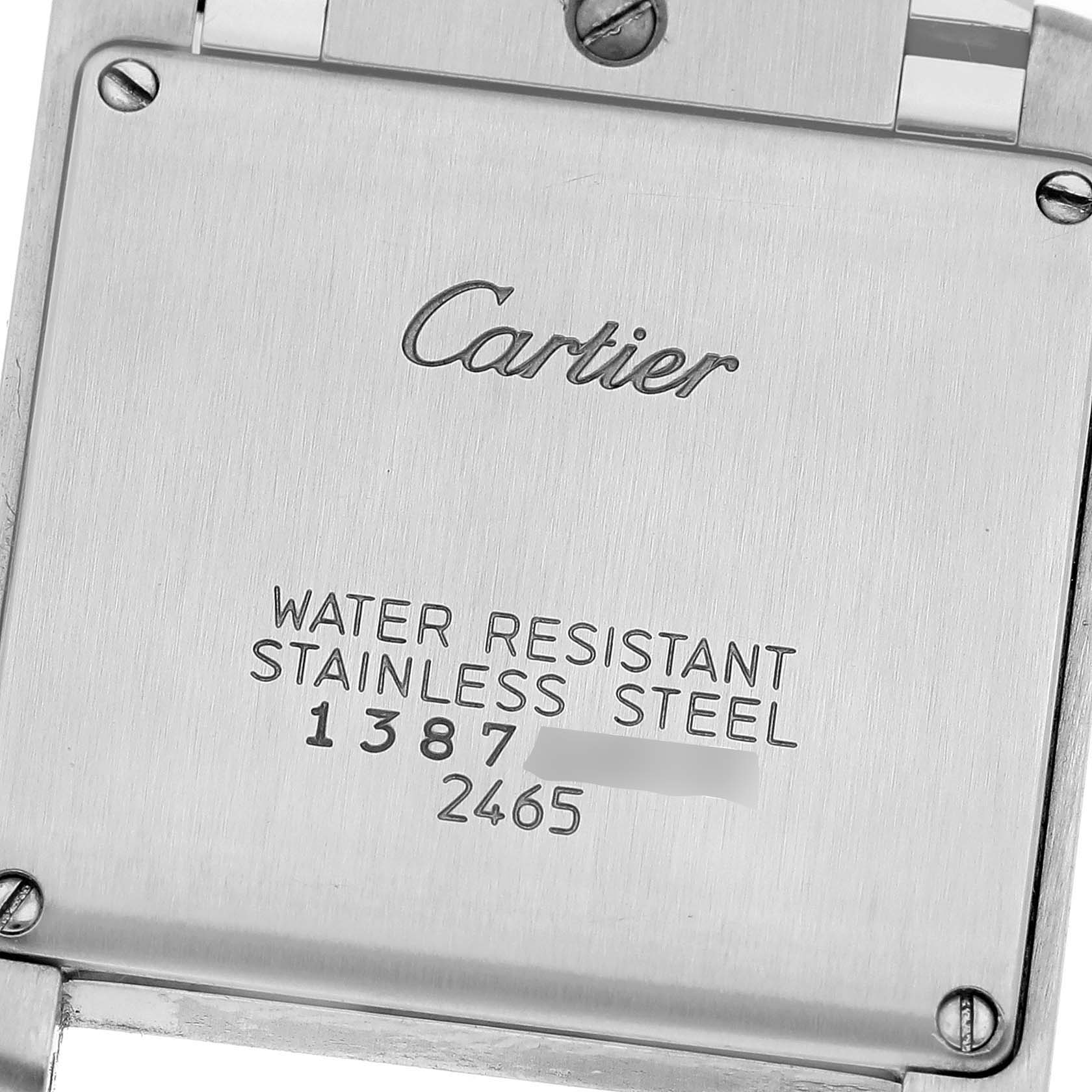 This image shows the back of a Cartier Tank Française watch, revealing the brand name, model, and material information.