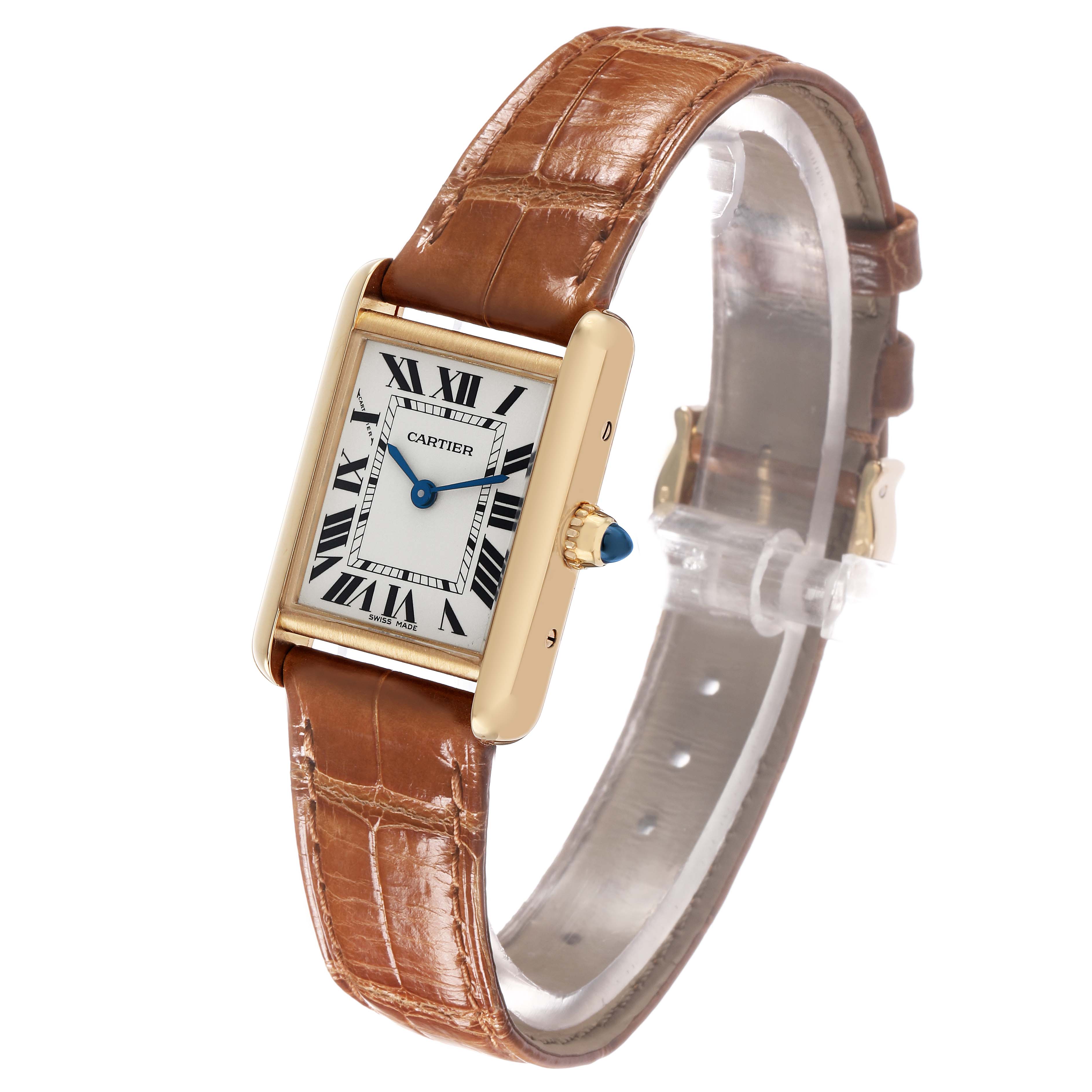 This Cartier Tank Louis W1529856 Women's Yellow Gold Silver Dial watch is shown at a three-quarter angle, displaying its rectangular face, gold case, brown leather strap, and blue crown.