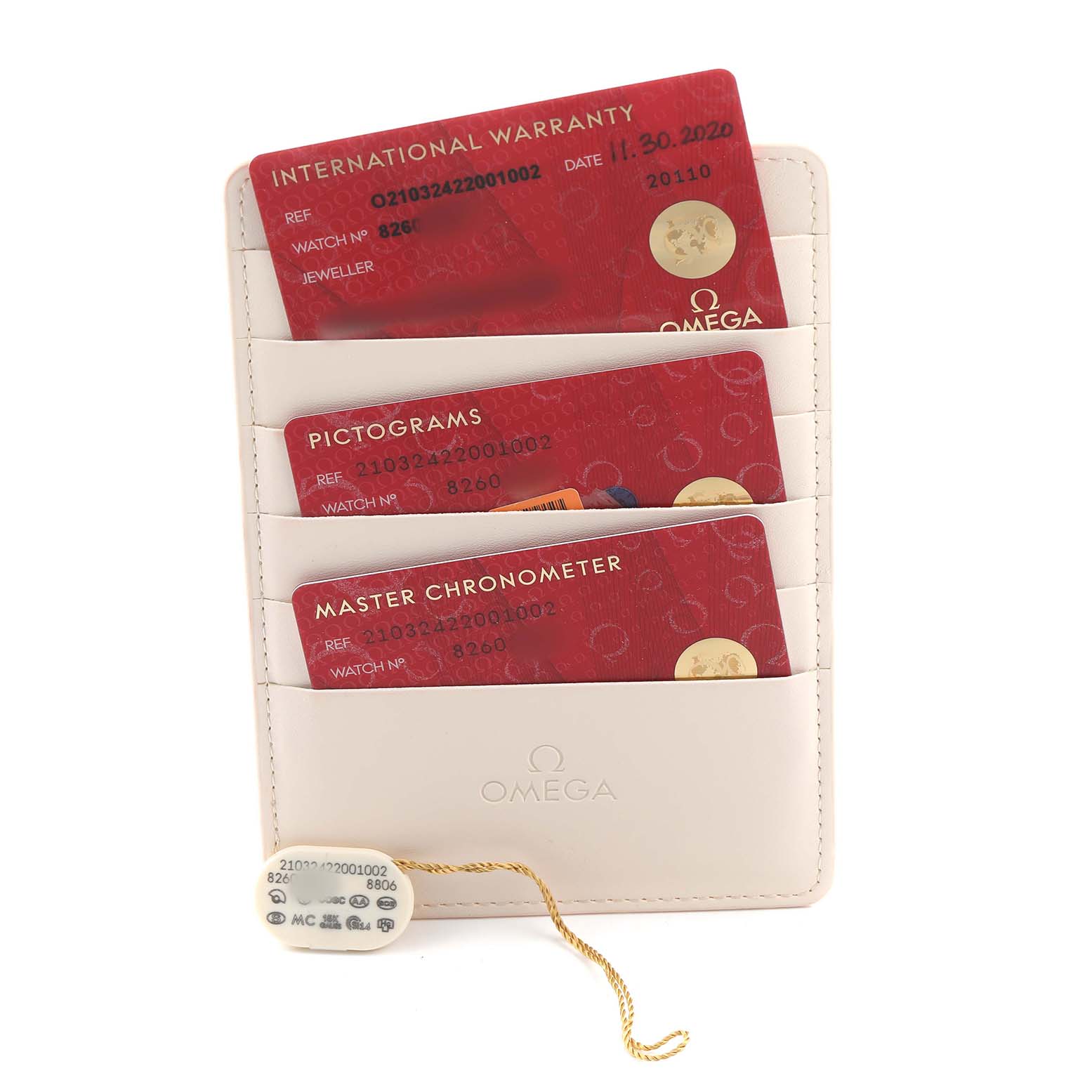 The image shows the warranty and authenticity cards for the Omega Seamaster 210.32.42.20.01.002 Men's Stainless Steel Black Dial, along with a tag.