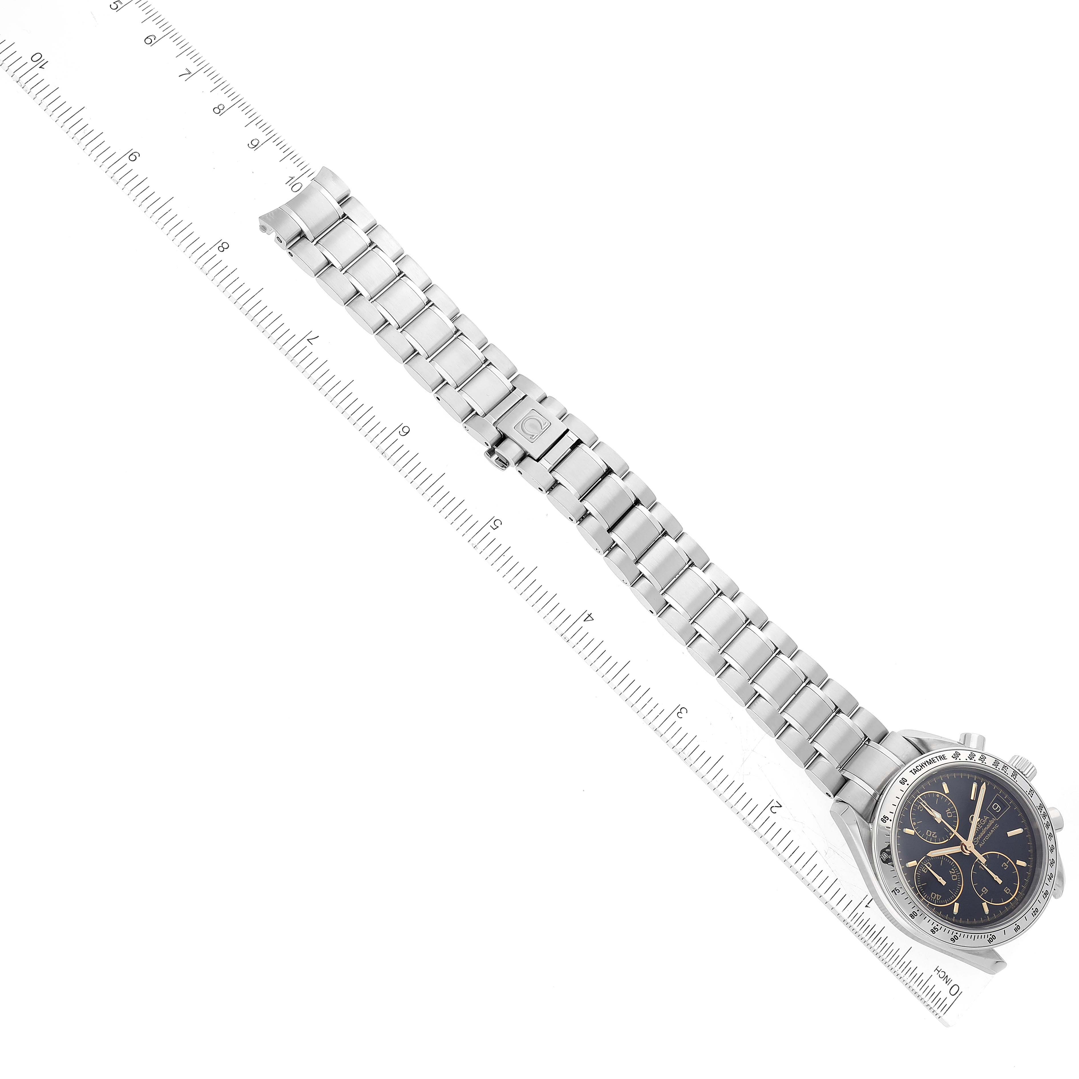 The image shows an Omega Speedmaster 3513.54.00 Men
s Stainless Steel Black Dial 3513.54.00 Men
s Stainless Steel Black Dial watch laid flat next to a ruler, displaying the face and metal bracelet.