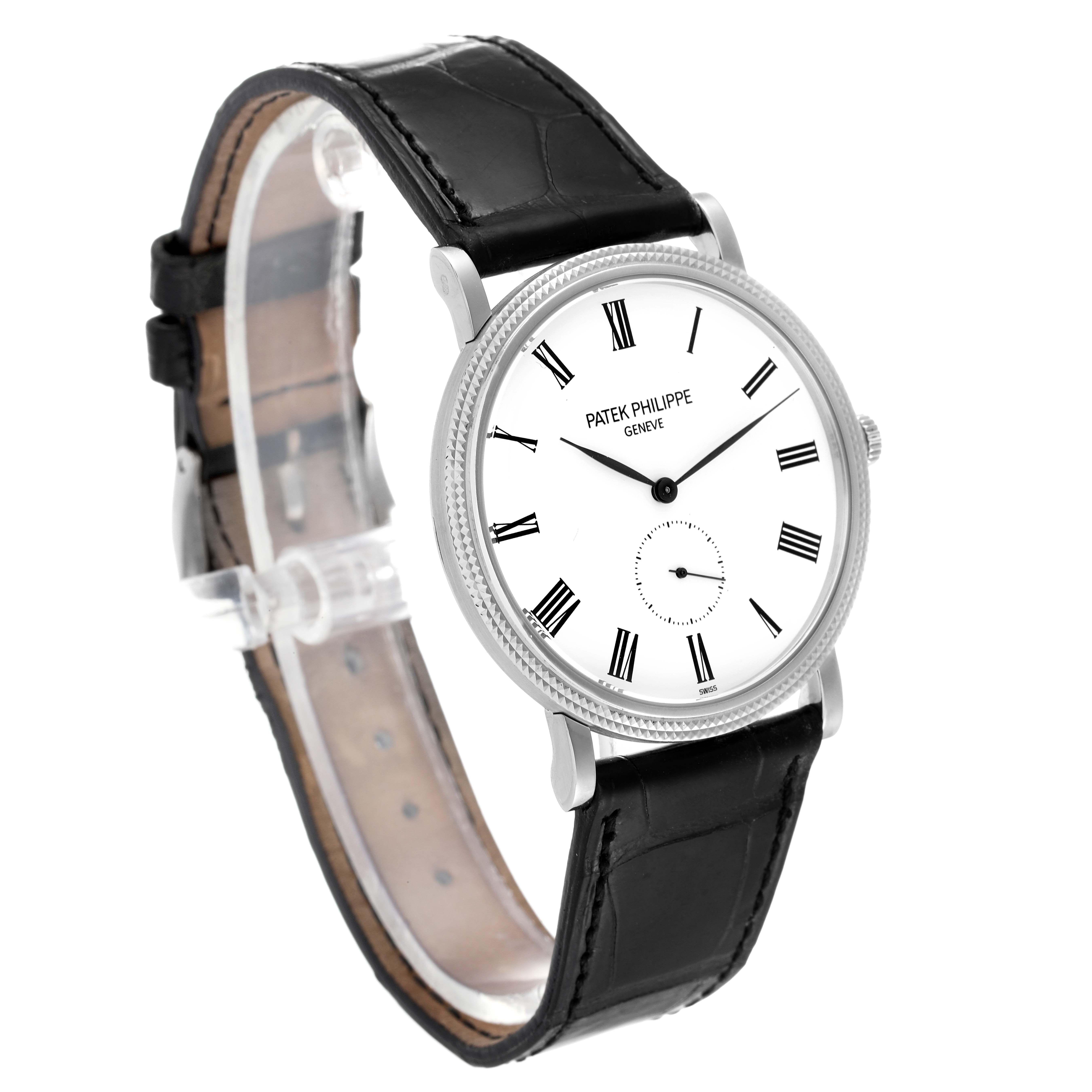 The Patek Philippe Calatrava 5119G Men's White Gold White Dial 5119G Men's White Gold White Dial watch is shown at a slight angle, displaying its white dial, black Roman numerals, and black leather strap.