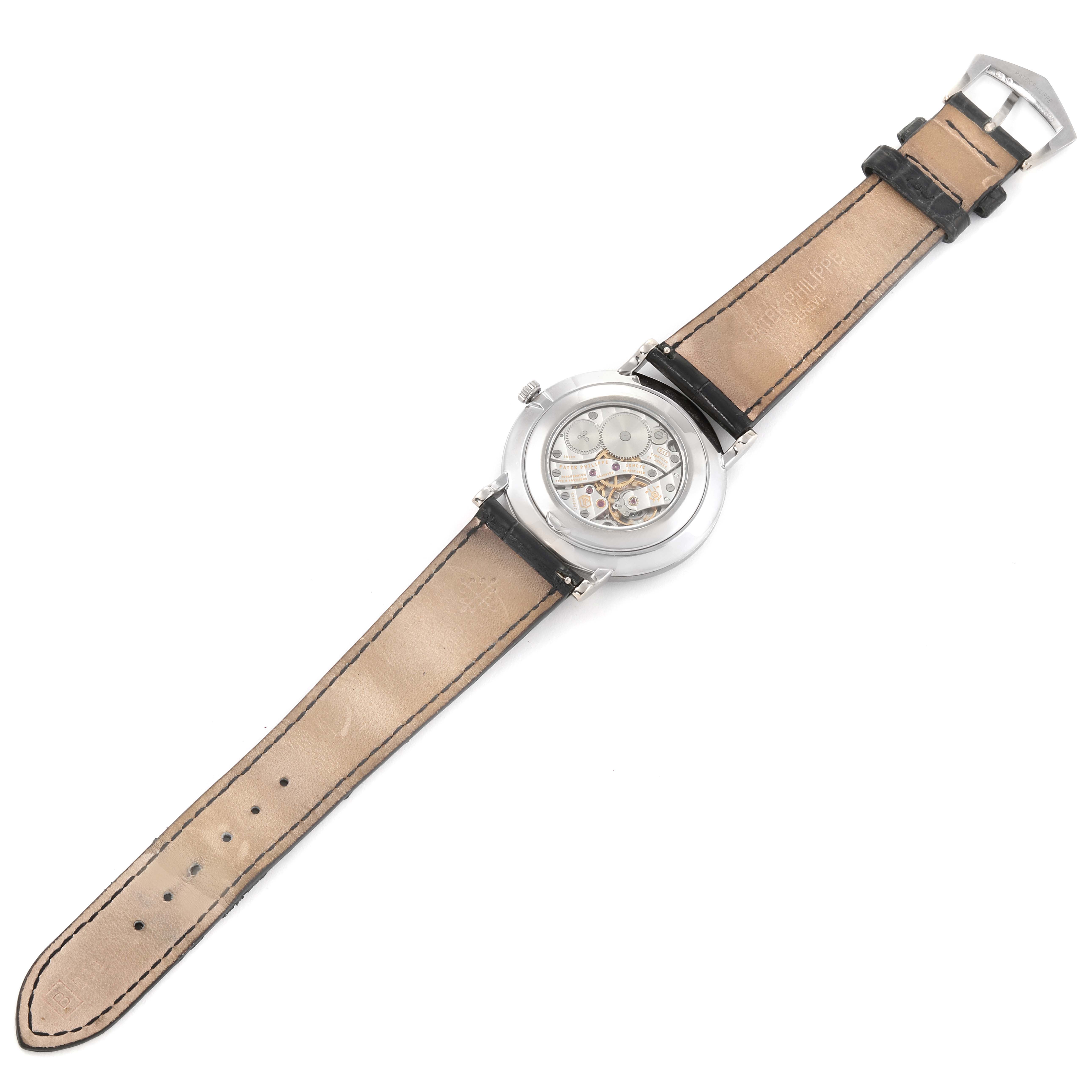 This image shows the back view of the Patek Philippe Calatrava 5119G Men's White Gold White Dial 5119G Men's White Gold White Dial watch, displaying its internal mechanism and leather straps.