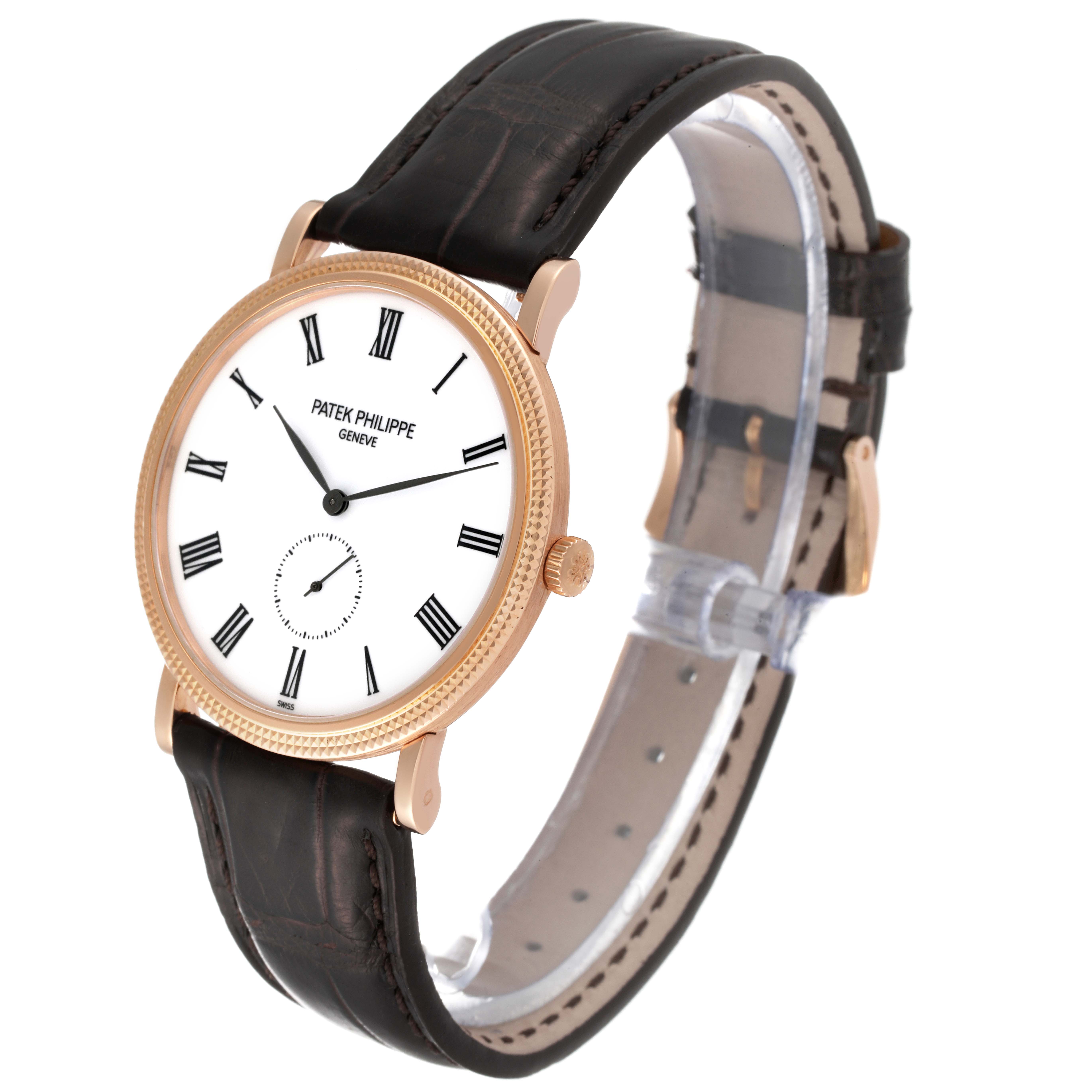 This image shows a Patek Philippe Calatrava 5119R Men
s Rose Gold White Dial 5119R Men
s Rose Gold White Dial watch from an angled side view, highlighting its face, case, and leather strap.