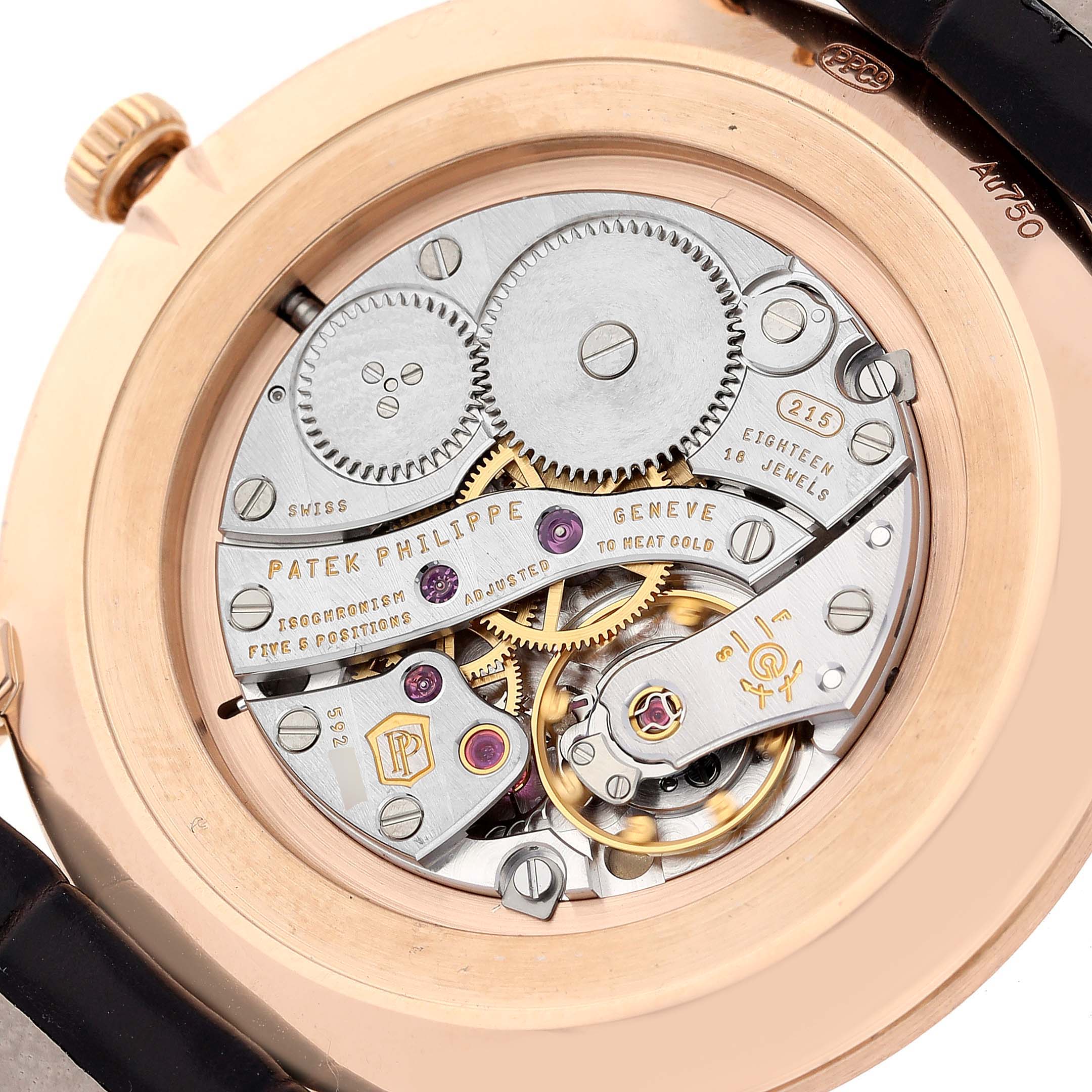 The image shows the reverse side of a Patek Philippe Calatrava 5119R Men
s Rose Gold White Dial 5119R Men
s Rose Gold White Dial watch, displaying its intricate mechanical movement and inner workings.