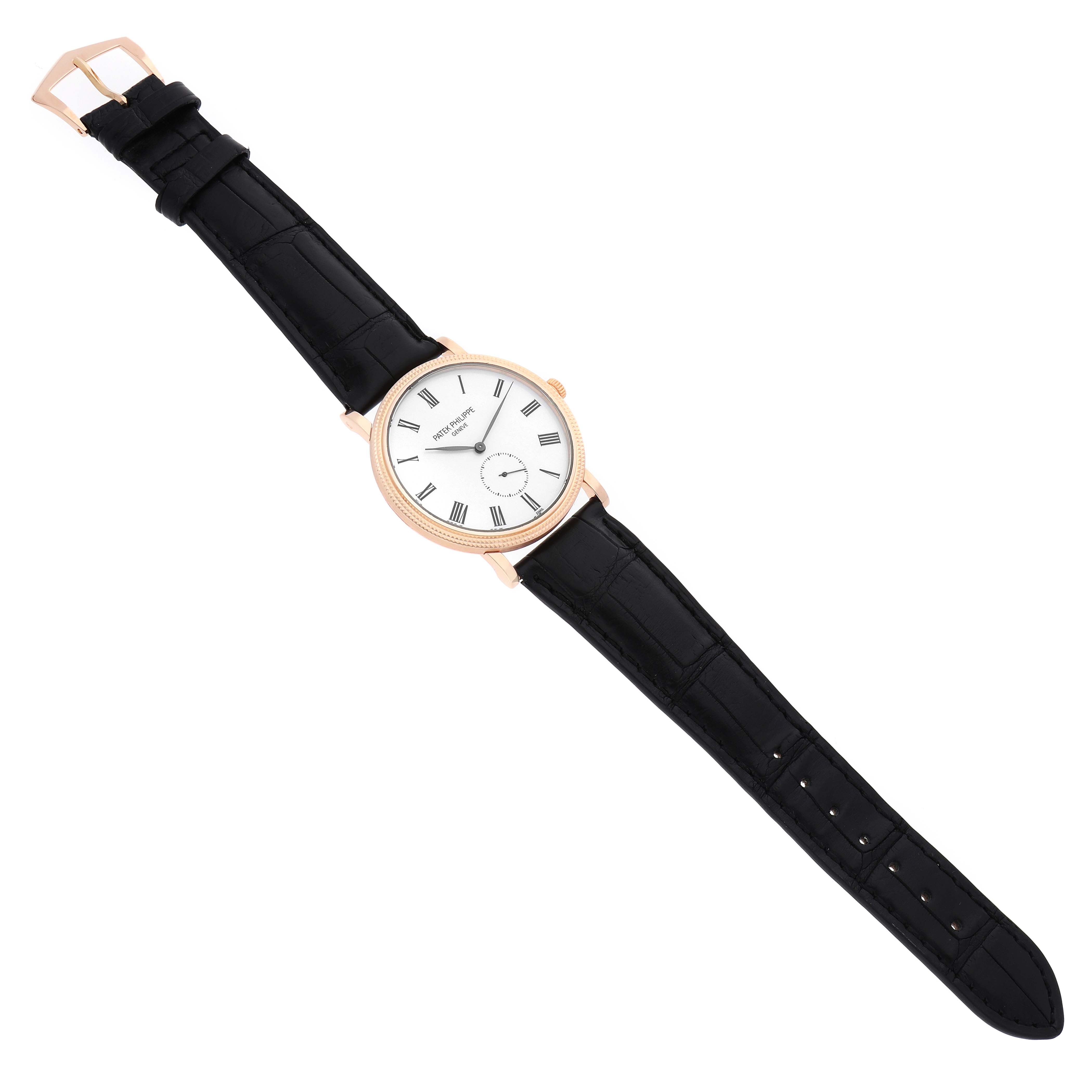 The Patek Philippe Calatrava 5116R Men's Rose Gold White Dial watch is shown from a top-down angle, displaying the entire watch face, strap, and buckle.