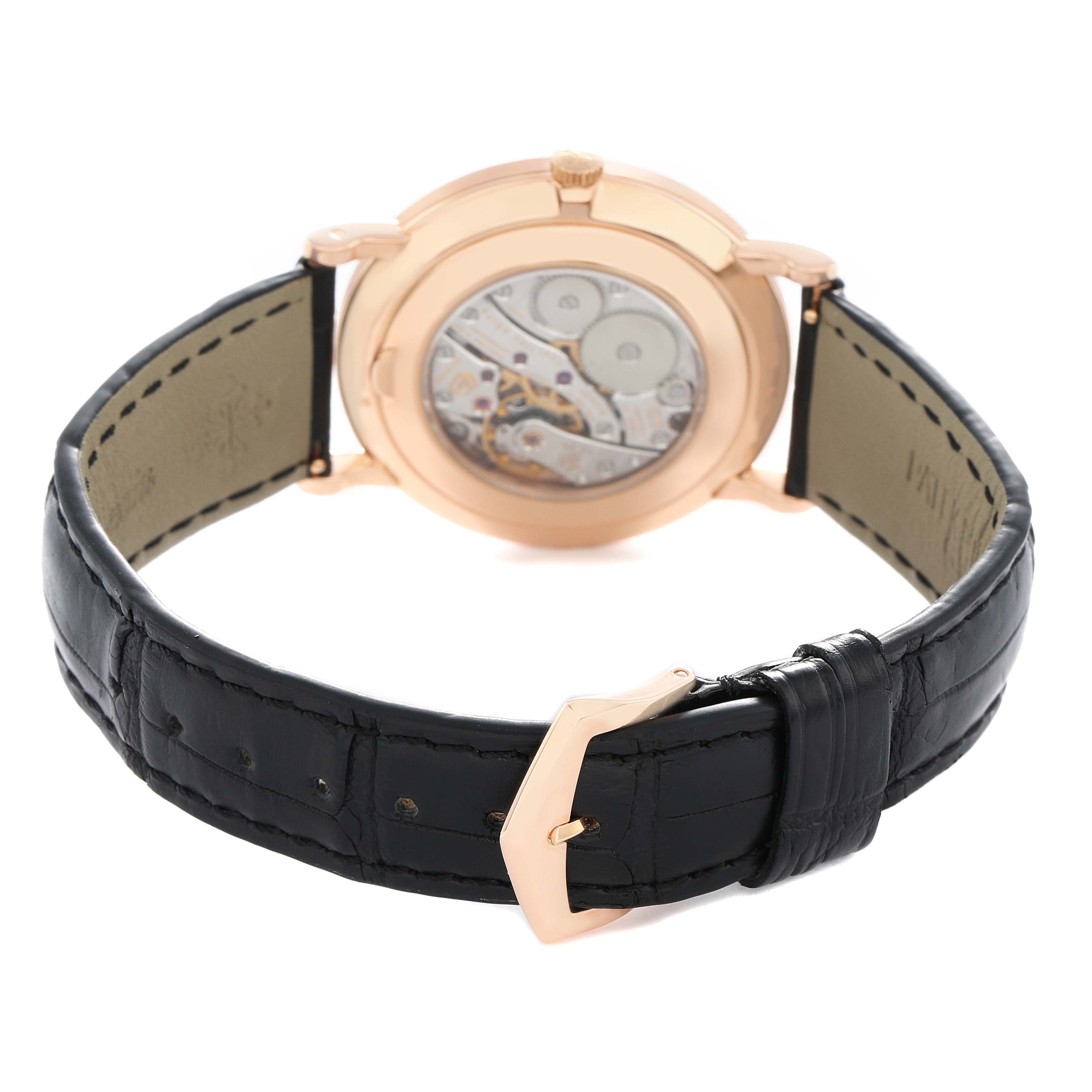 The Patek Philippe Calatrava 5116R Men's Rose Gold White Dial watch is shown from the back, displaying the open caseback and black leather strap.