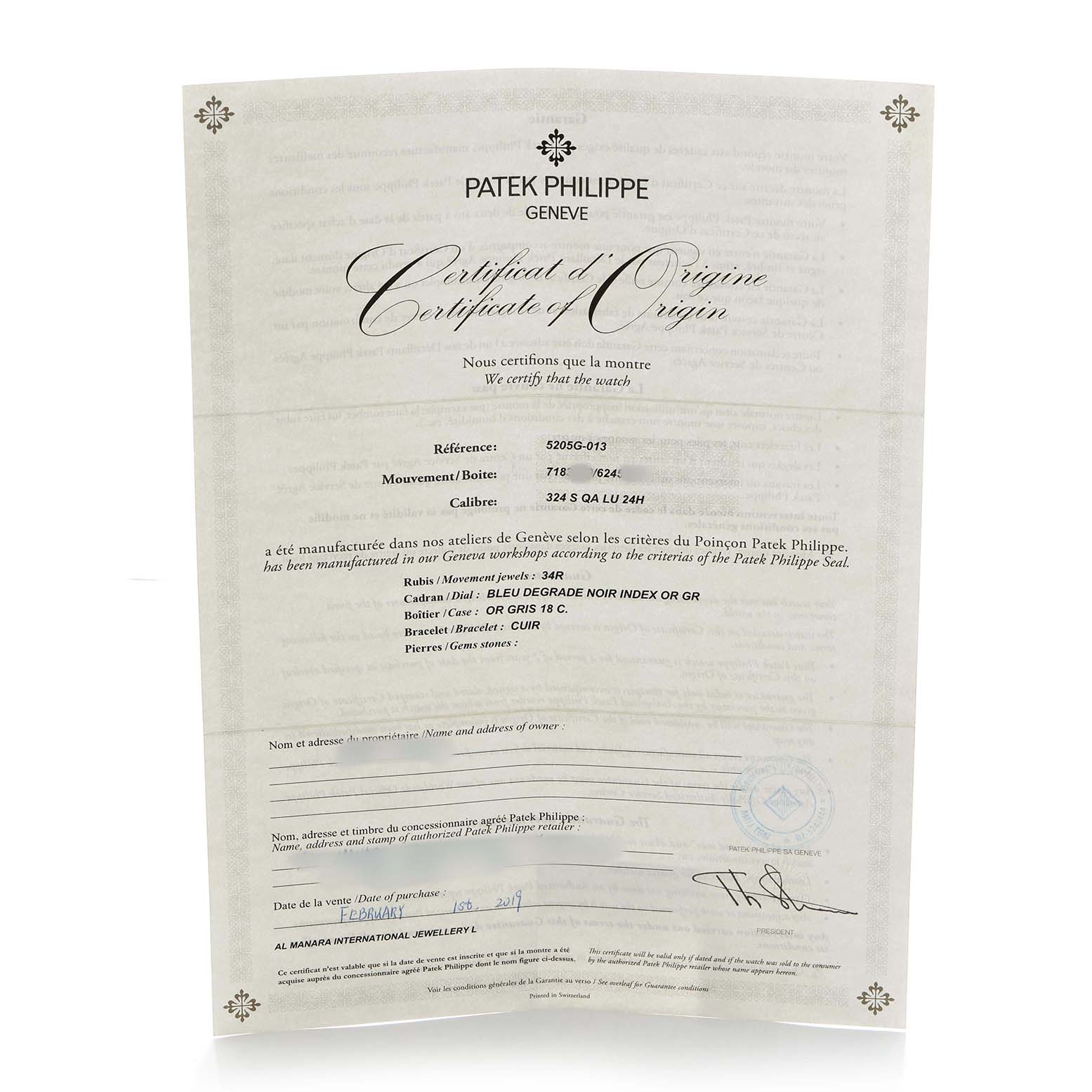 The image shows a Certificate of Origin for a Patek Philippe Complications 5205G-013 Men's White Gold Blue Dial watch, displaying text and official details.