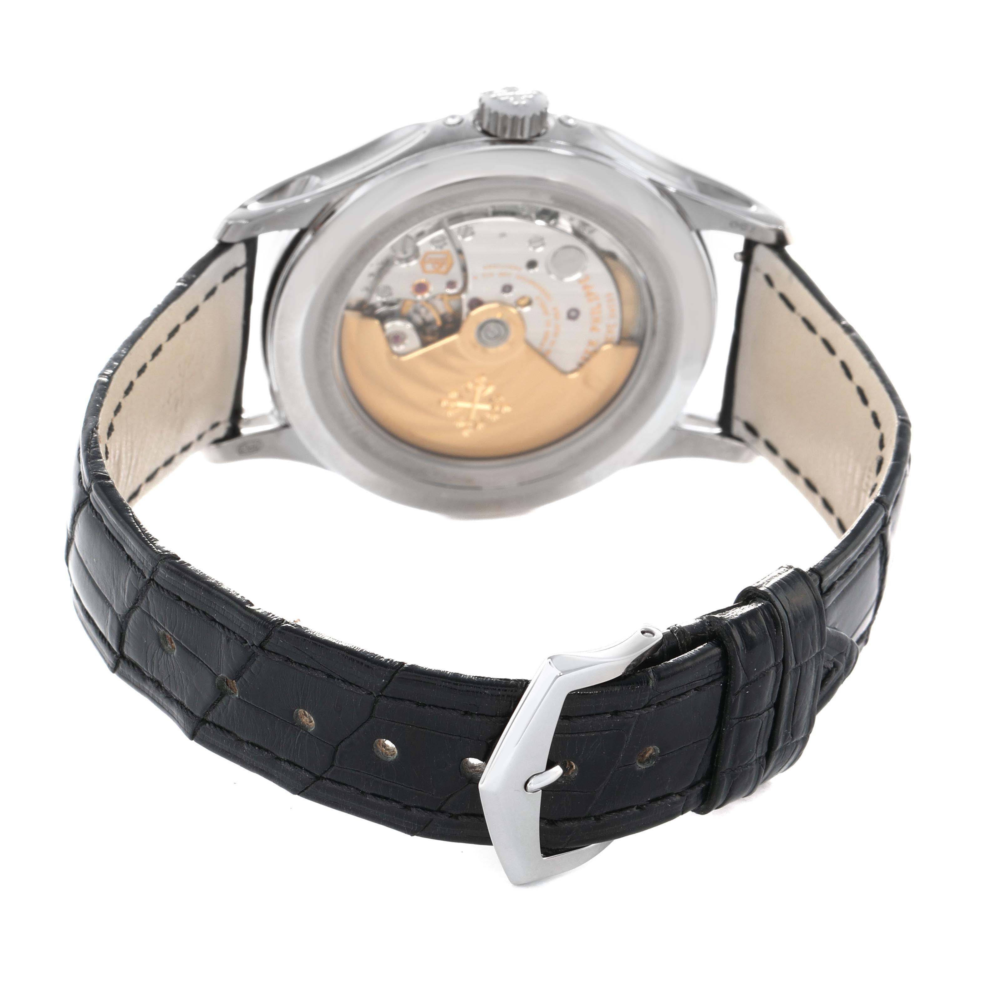 The image shows the rear view of a Patek Philippe Complications 5205G-013 Men's White Gold Blue Dial watch, highlighting the movement and leather strap with a buckle.