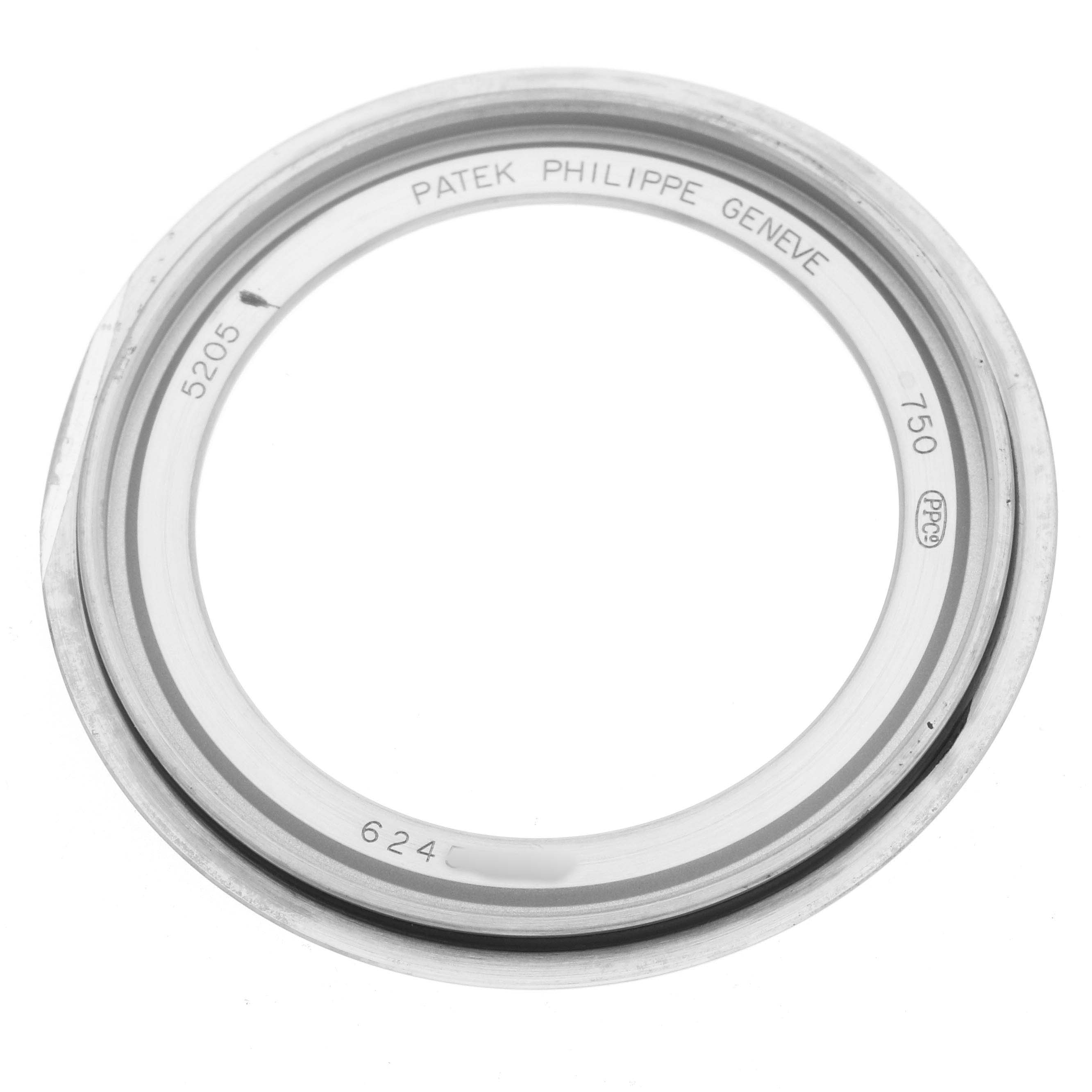 The image shows a Patek Philippe Complications 5205G-013 Men's White Gold Blue Dial model watch bezel or case rim with engravings viewed from above.