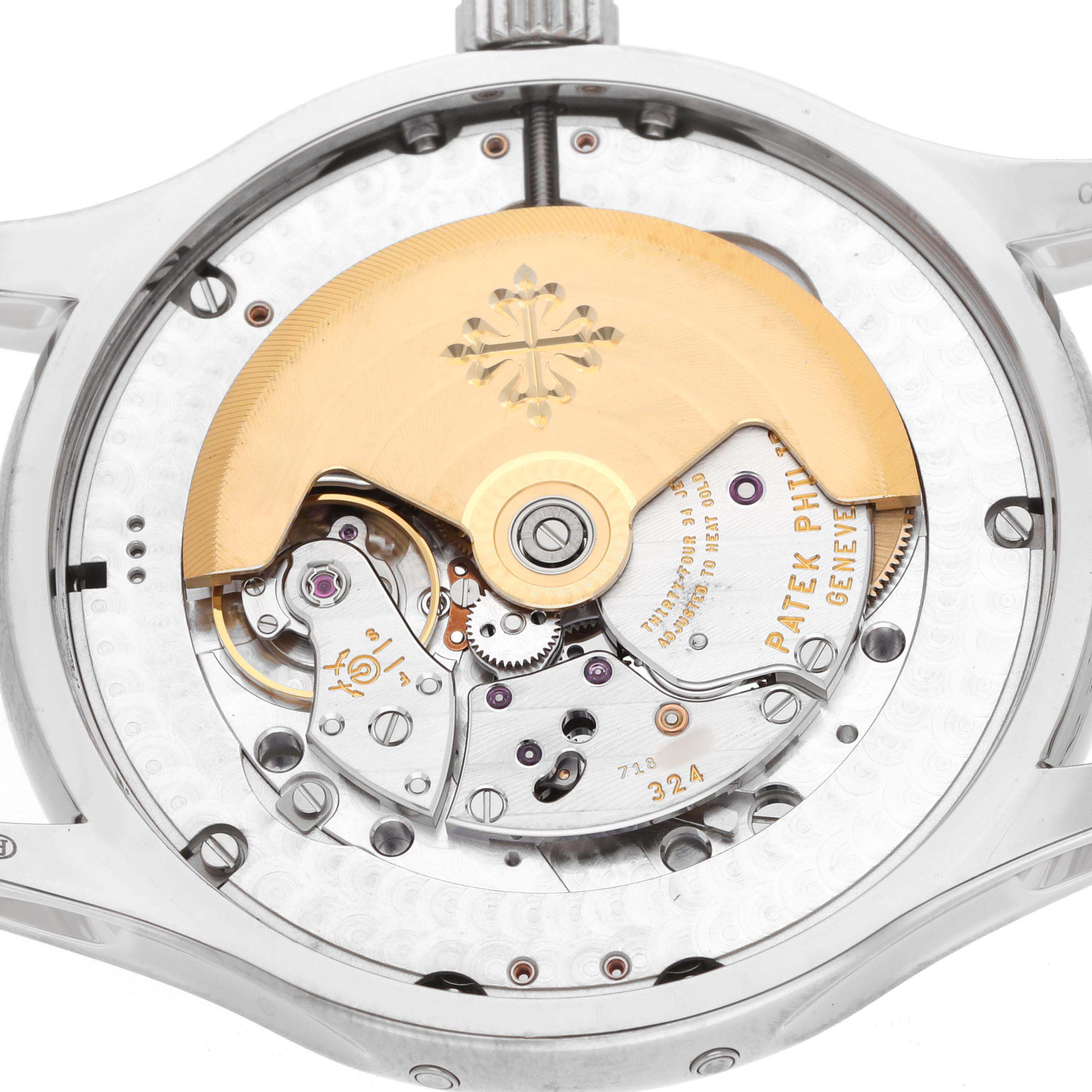 The image shows the back view of a Patek Philippe Complications 5205G-013 Men's White Gold Blue Dial watch, highlighting its intricate movement and rotor.