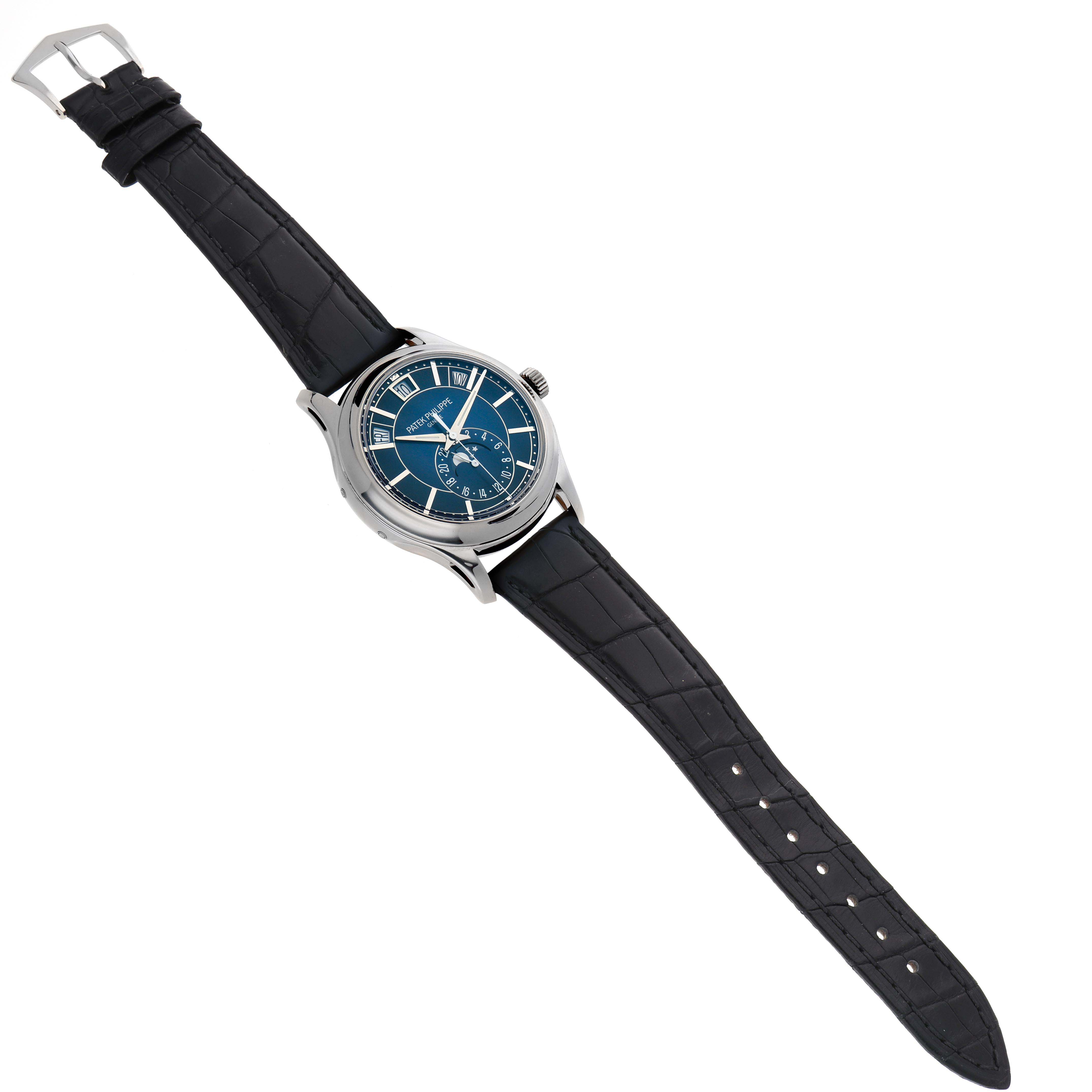 The image shows a Patek Philippe Complications 5205G-013 Men's White Gold Blue Dial watch at an angled top view, displaying its face, bezel, and full leather strap.