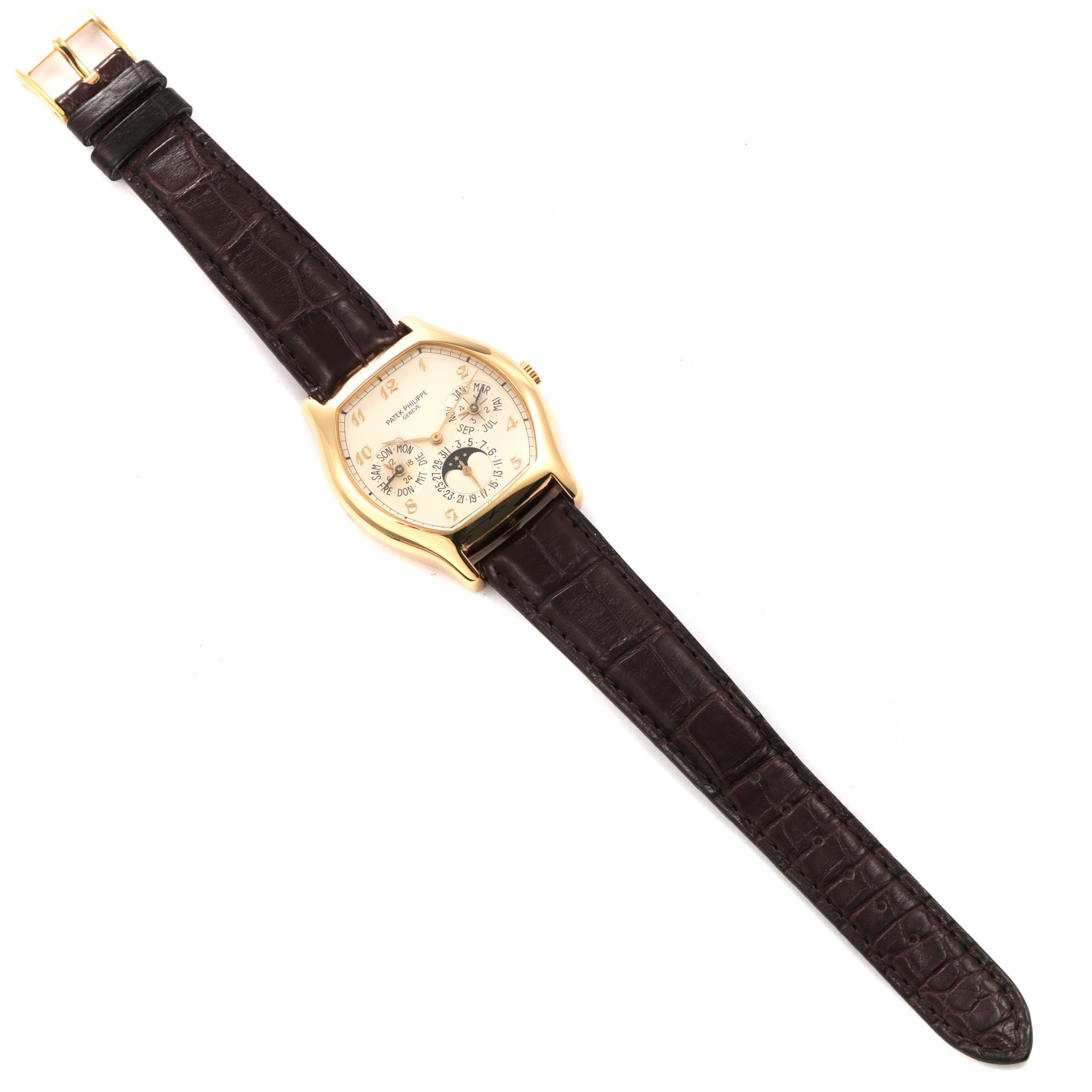 The image shows a top-down view of a Patek Philippe Complications 5040 Men's Yellow Gold Silver Dial 5040 Men's Yellow Gold Silver Dial watch displaying the dial, strap, and buckle.