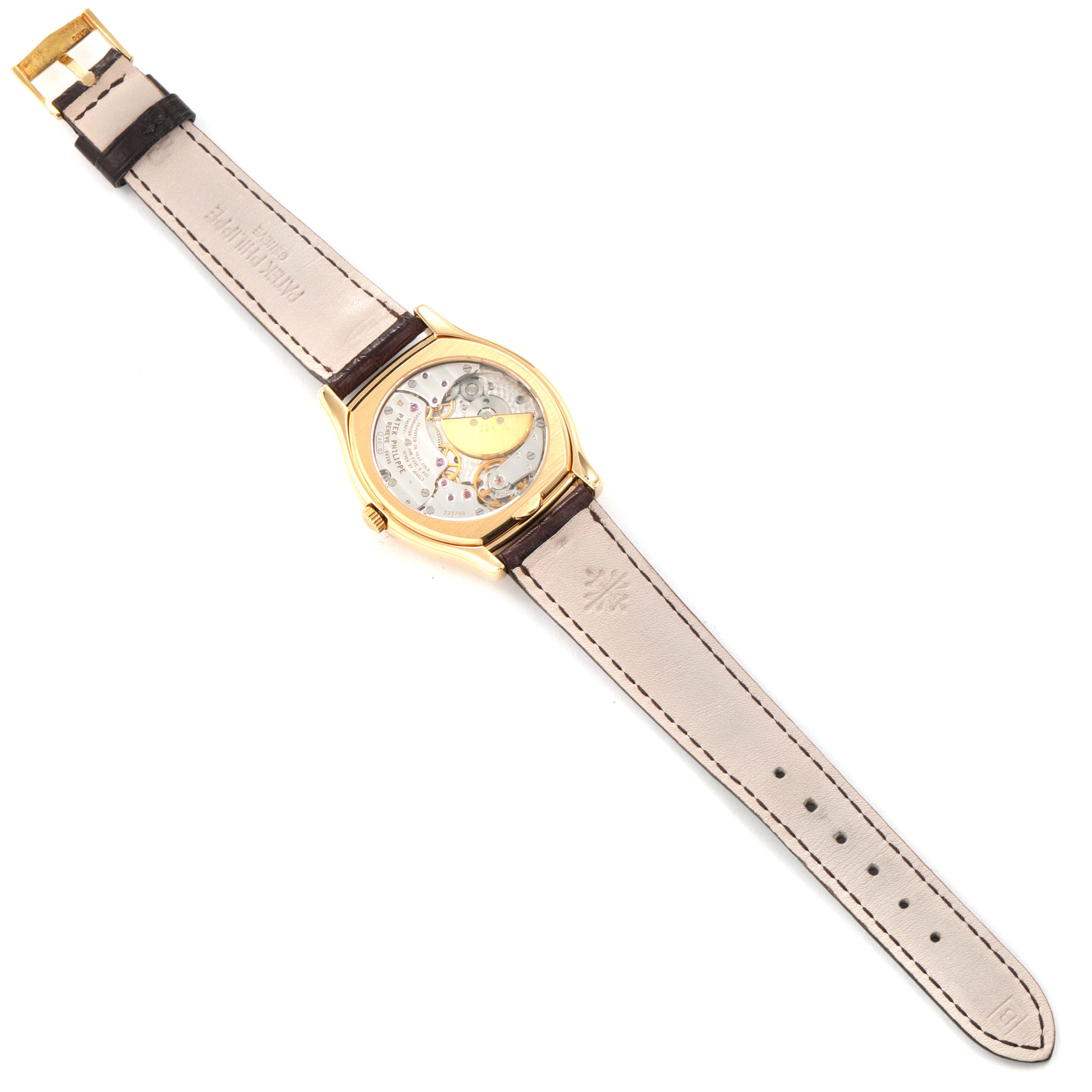 The image shows the back view of a Patek Philippe Complications 5040 Men's Yellow Gold Silver Dial 5040 Men's Yellow Gold Silver Dial model watch, displaying its inner mechanism and the leather strap.