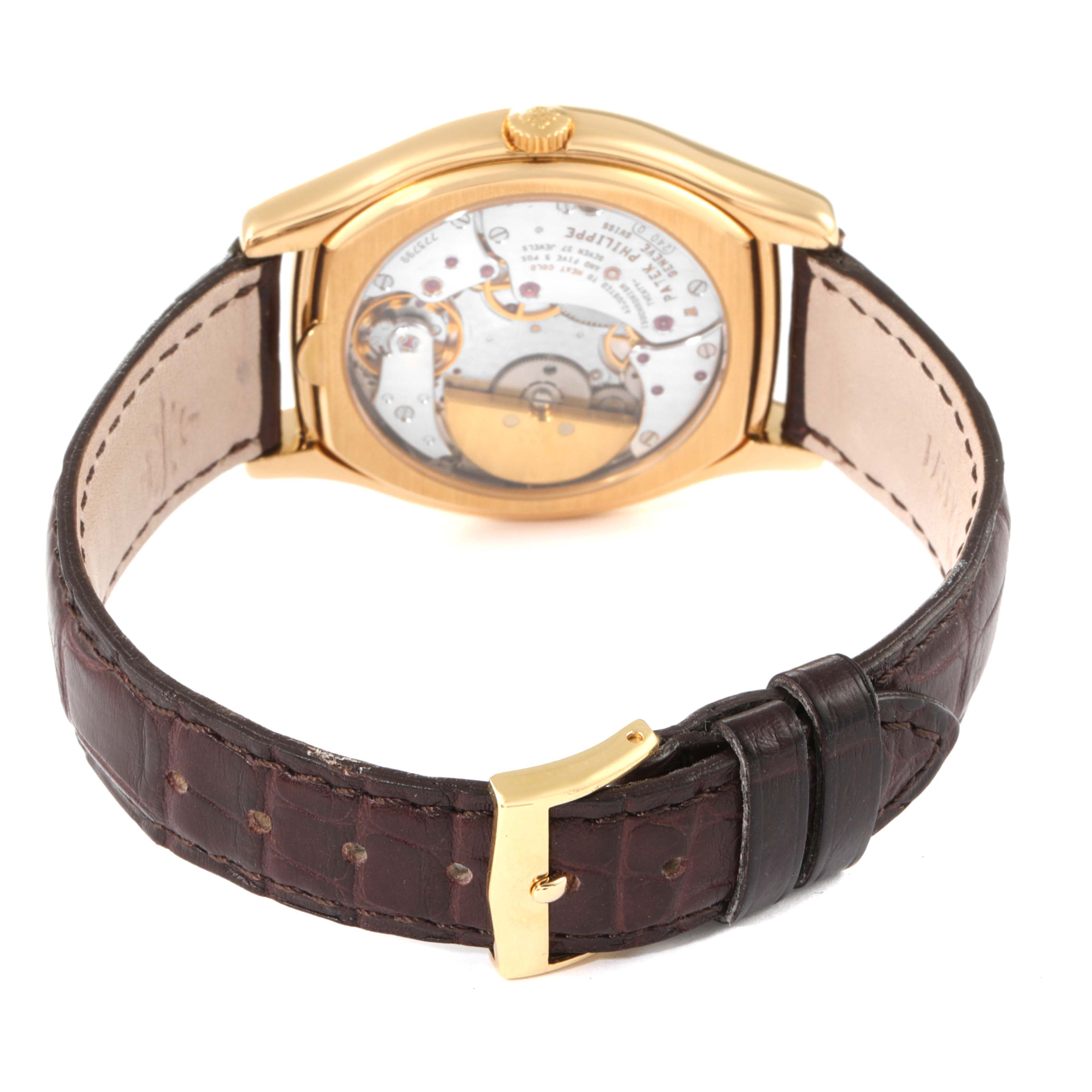 The image shows the Patek Philippe Complications 5040 Men's Yellow Gold Silver Dial 5040 Men's Yellow Gold Silver Dial model from the back, highlighting the movement and brown leather strap.