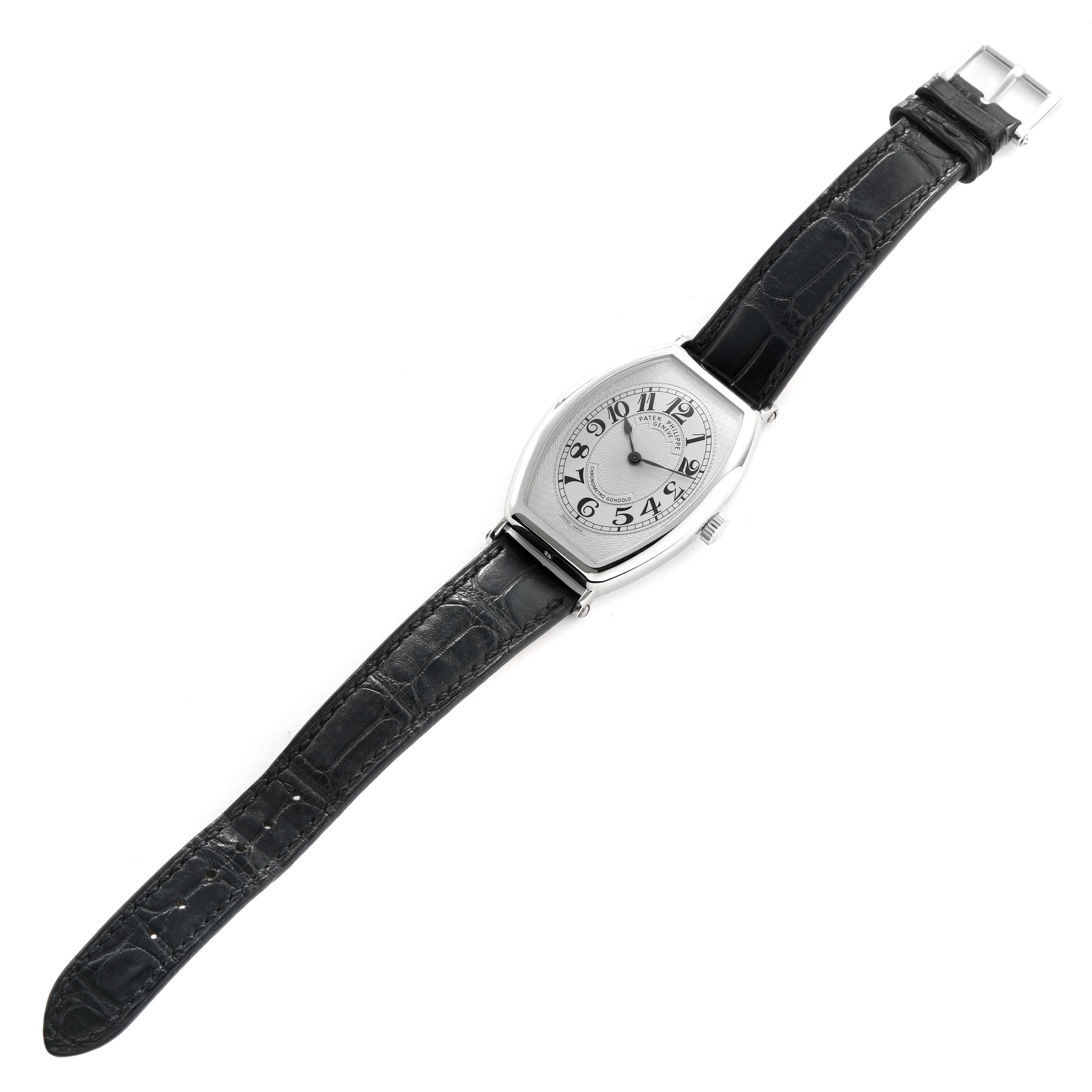The Patek Philippe Gondolo 5098P-001 Men's Platinum Silver Dial watch is shown from a top view, displaying its unique case shape, dial, and leather strap.